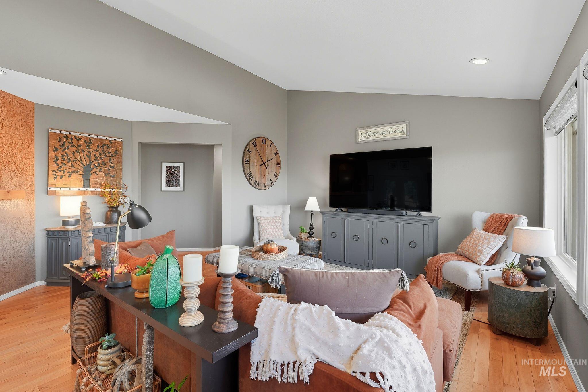 Living area featuring light wood-style flooring, recessed lighting, and lofted ceiling