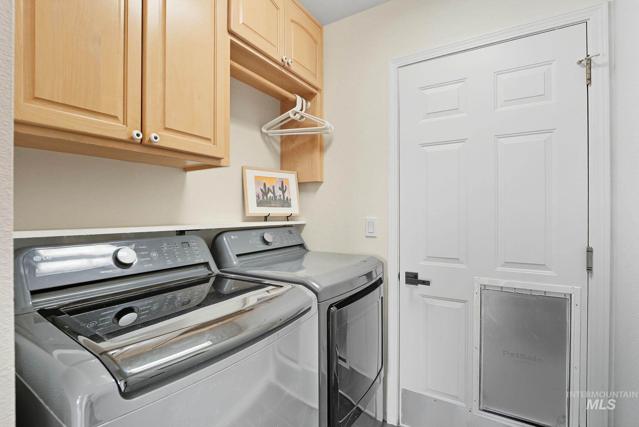 Laundry area with washing machine and dryer and cabinet space