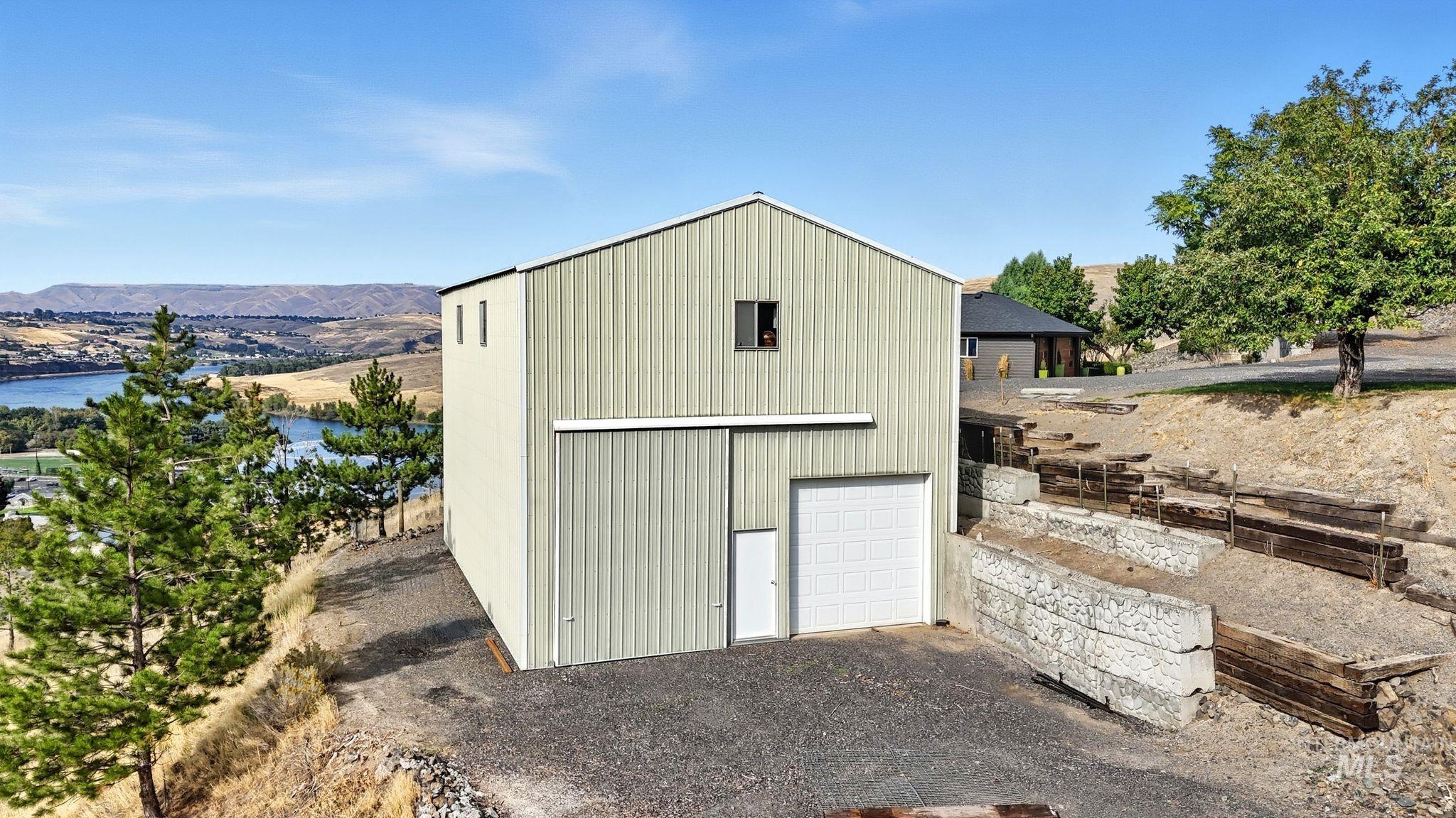 View of outdoor structure with a mountain view and a garage