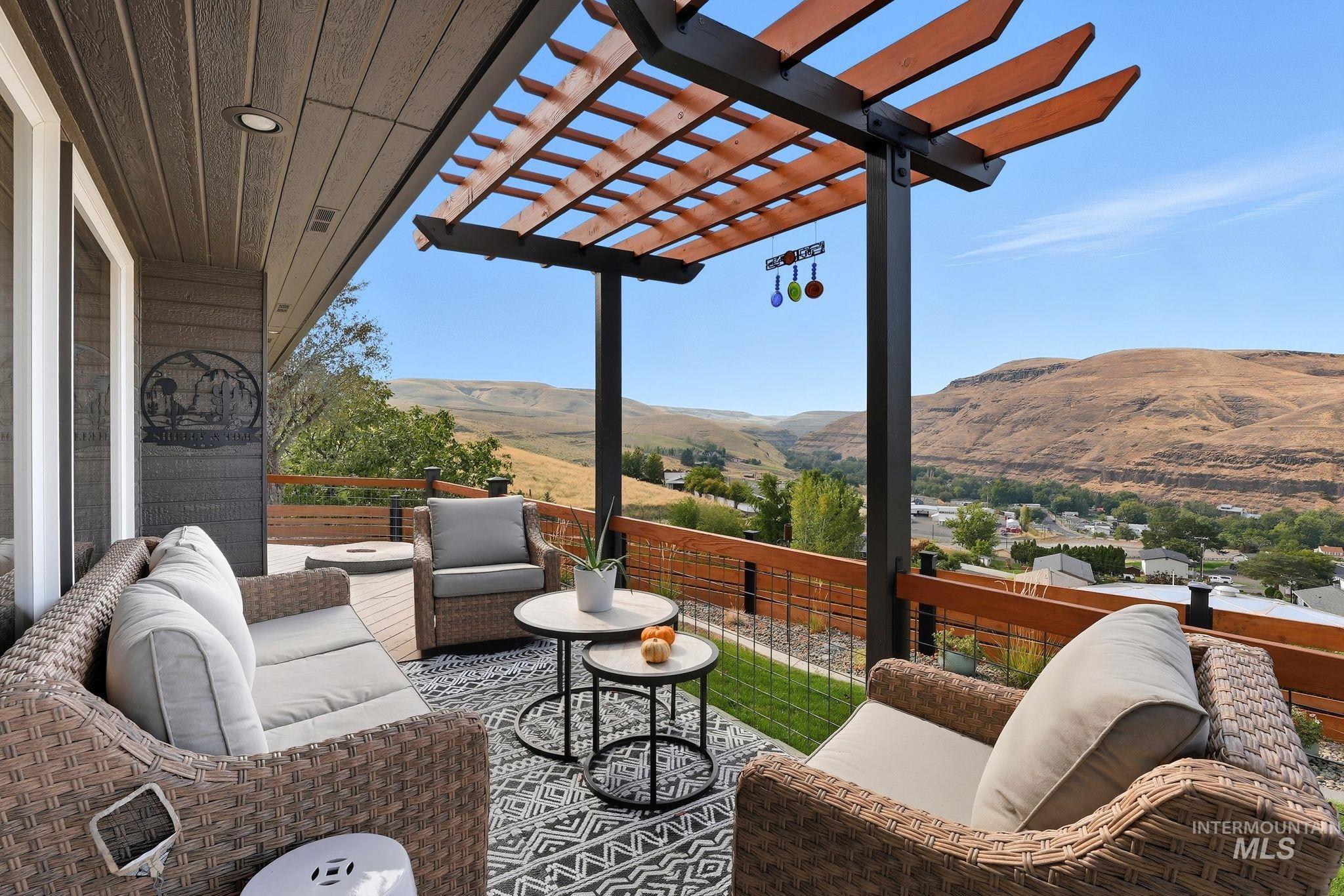 View of patio with a mountain view, a pergola, and an outdoor living space