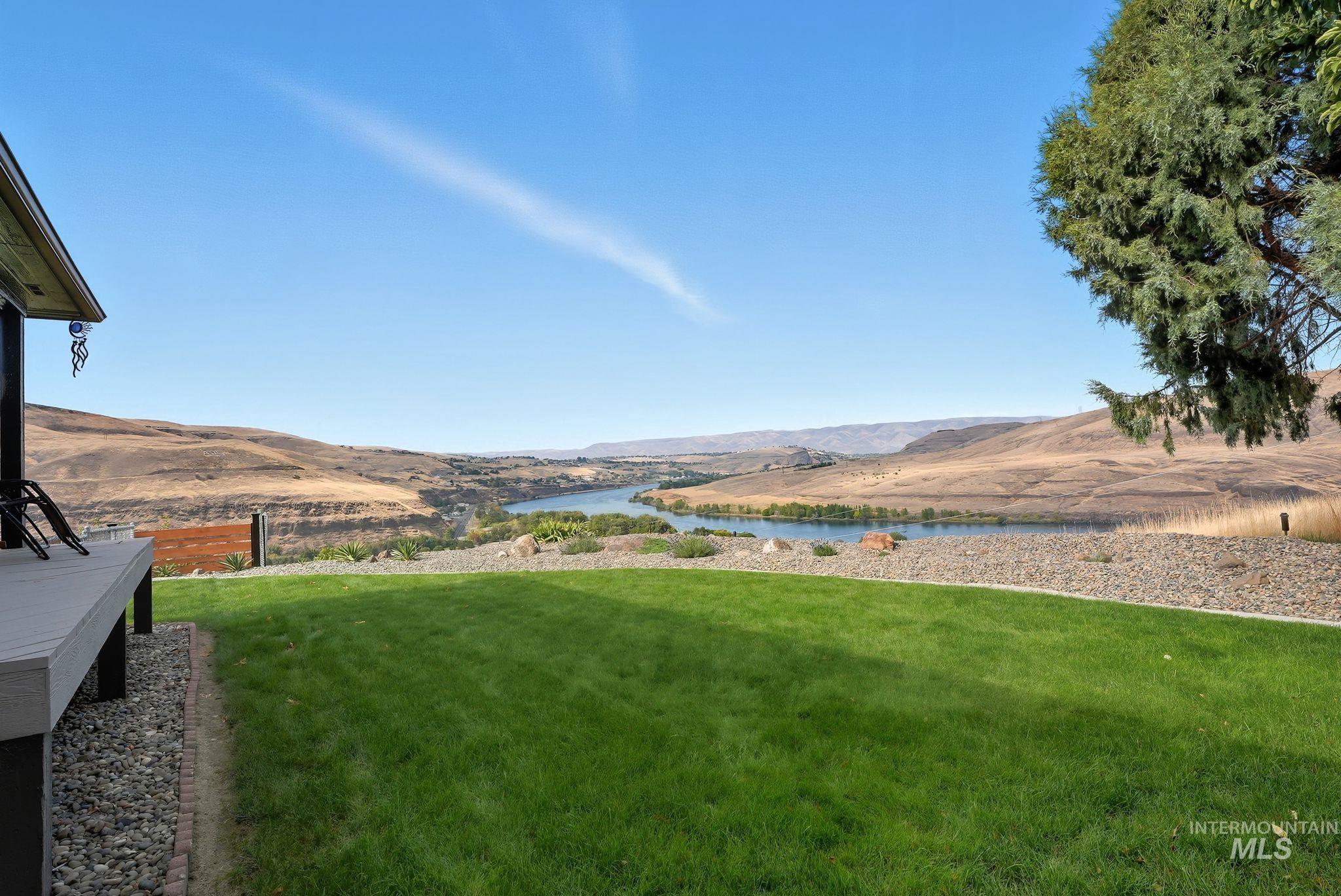 View of green lawn with a water and mountain view