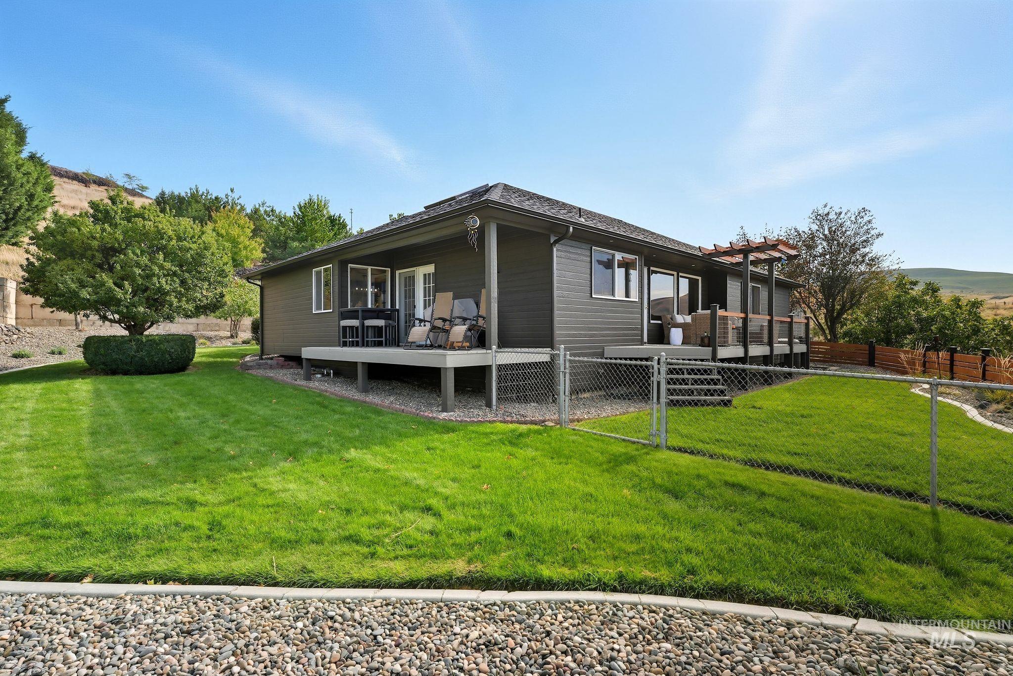 View of side of property with a wooden deck and a fenced backyard