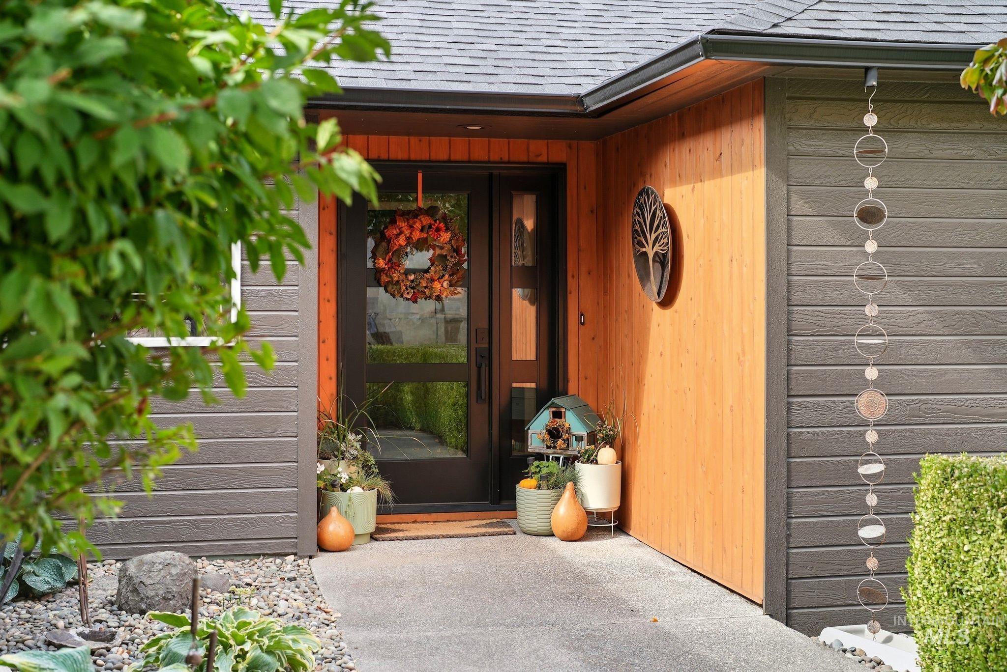 Entrance to property with roof with shingles