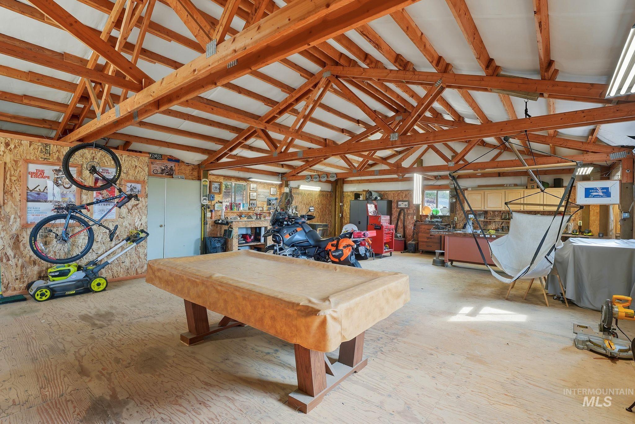 Rec room with lofted ceiling and billiards table