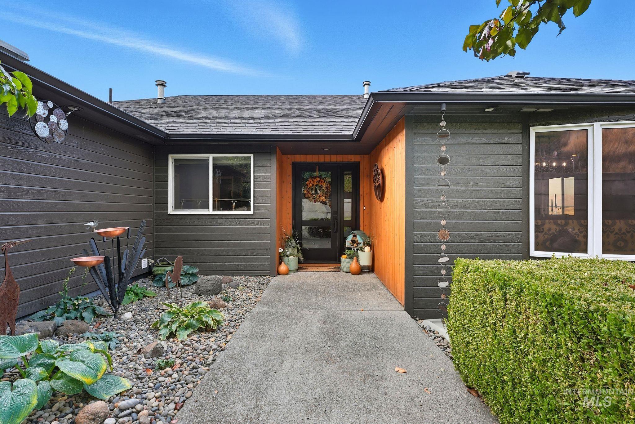 View of exterior entry featuring roof with shingles