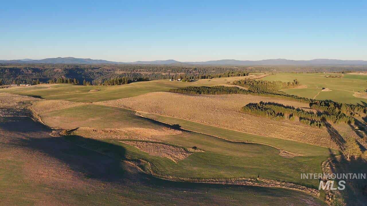 Aerial view of property and surrounding area with a mountain backdrop and a golf club