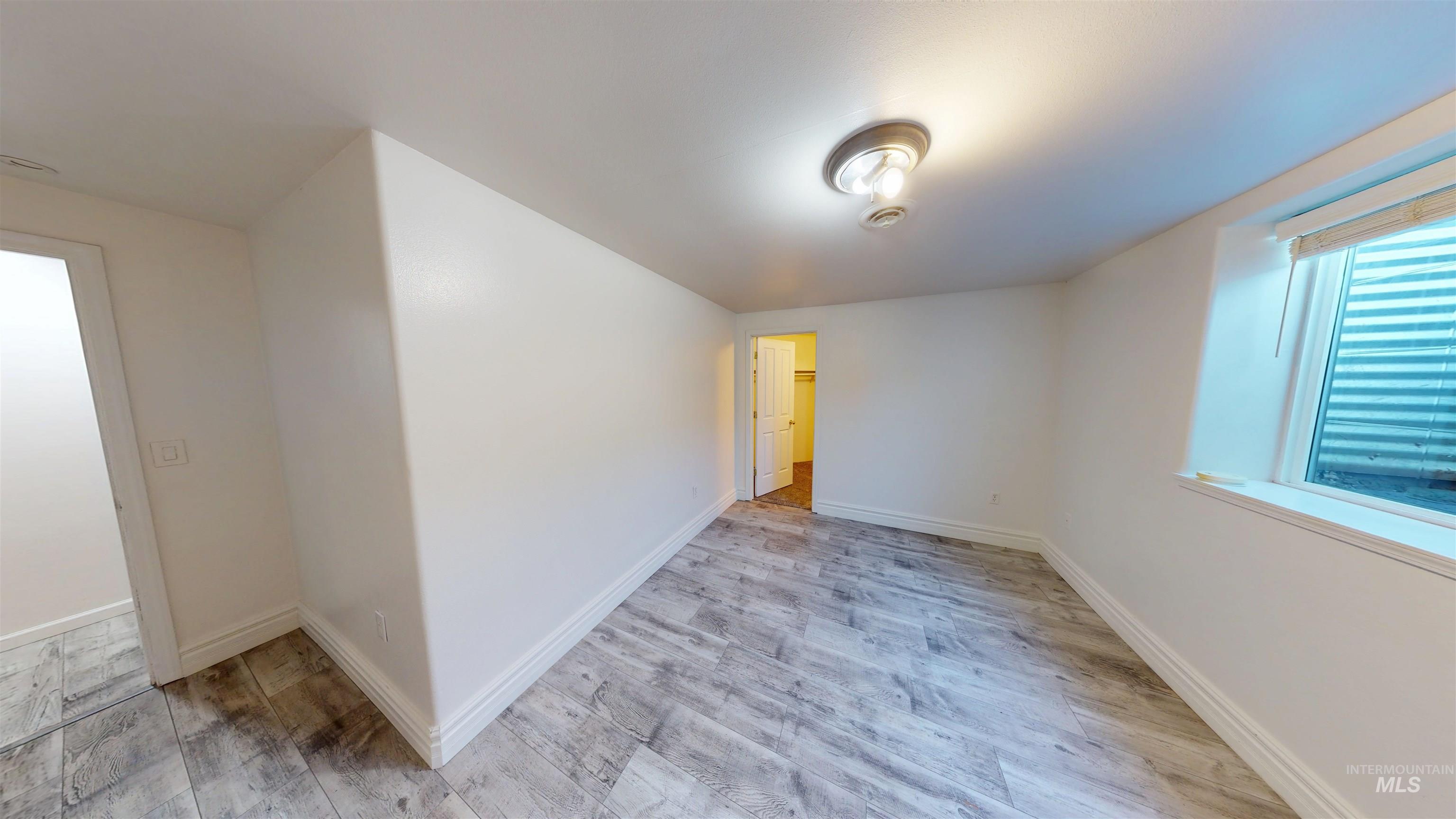 Unfurnished room featuring light wood-type flooring