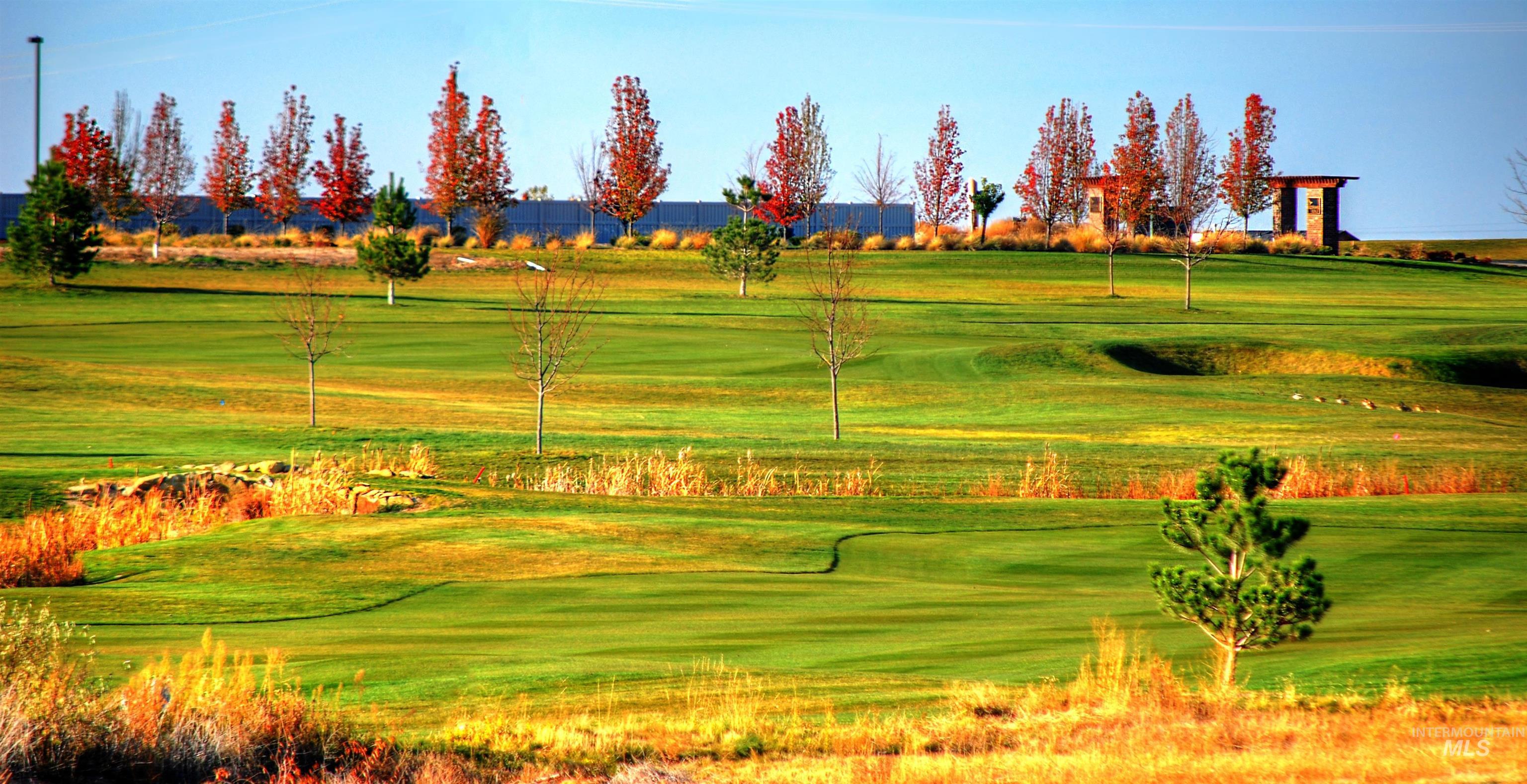 View of property's community with view of golf course and a yard