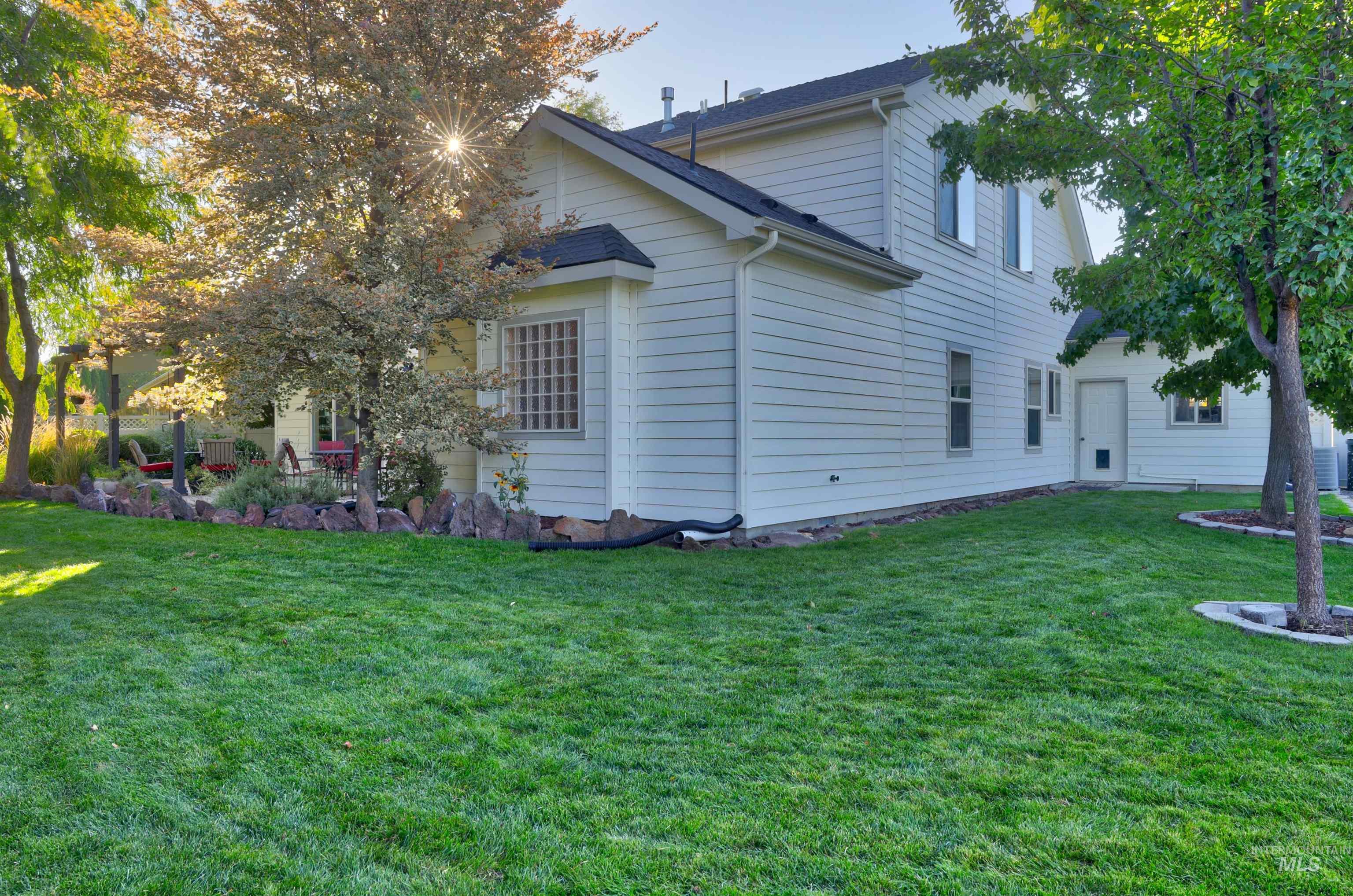 Back of property featuring a lawn