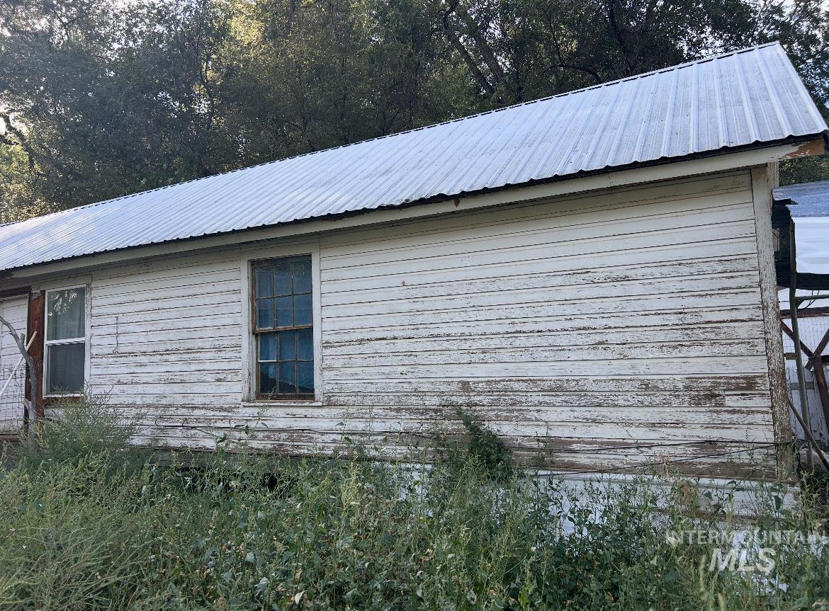 View of property exterior featuring a metal roof