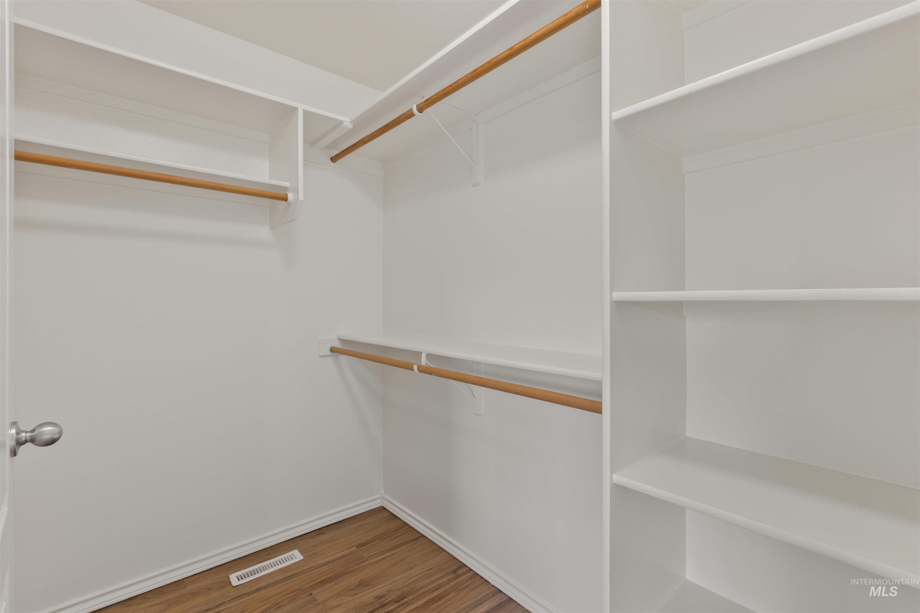 Walk in closet featuring wood finished floors