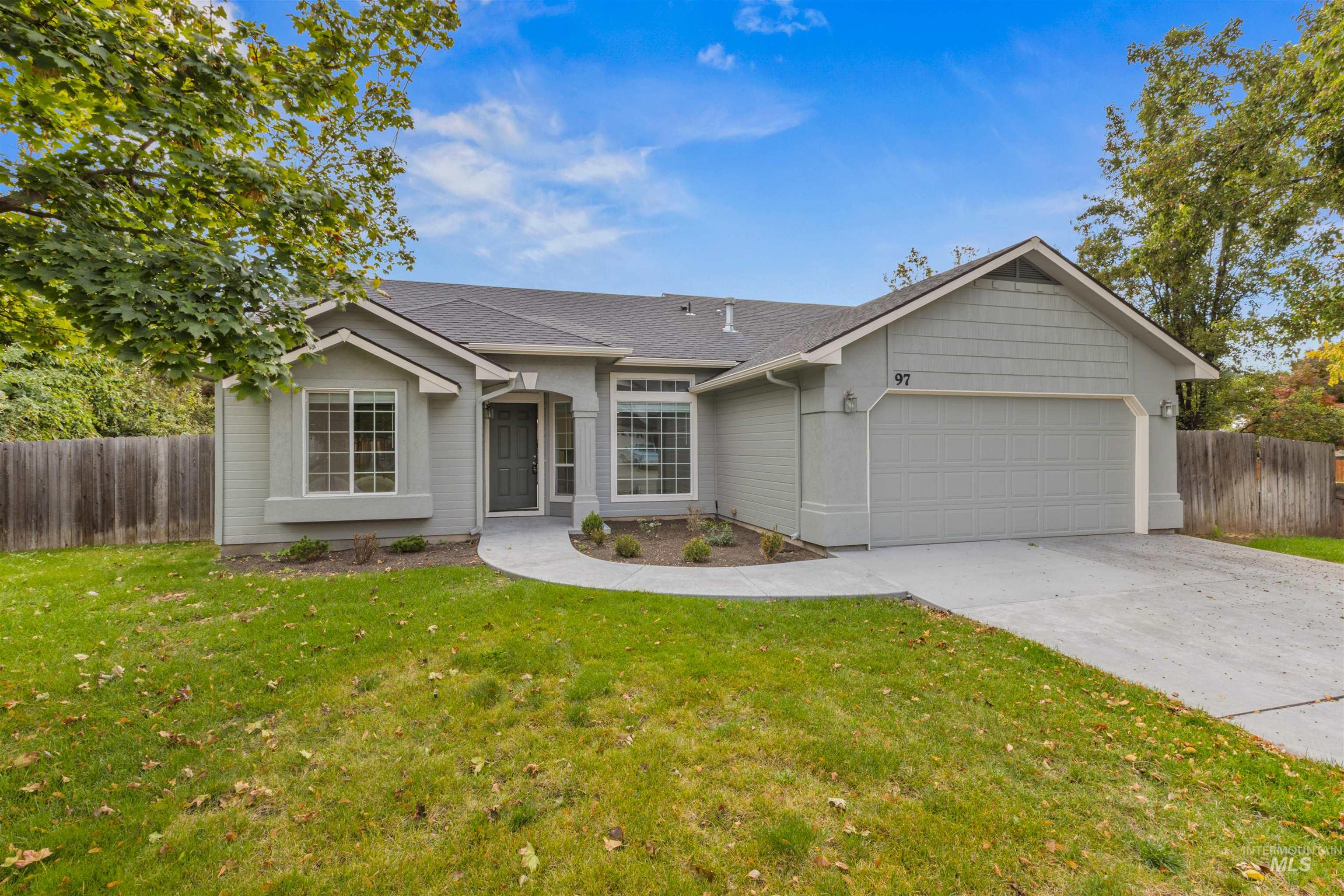 Single story home with driveway, a garage, and roof with shingles