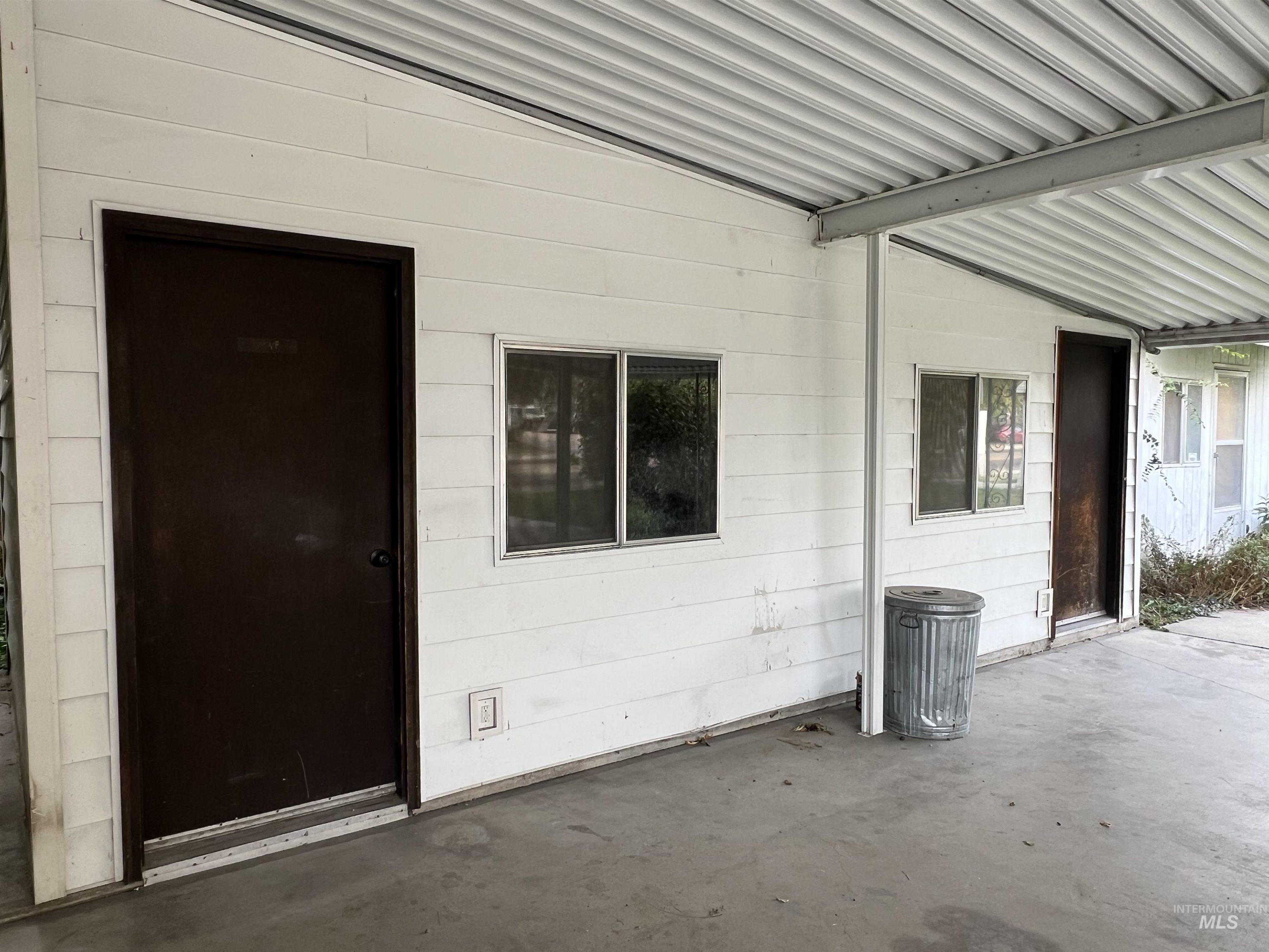 View of exterior entry featuring a patio