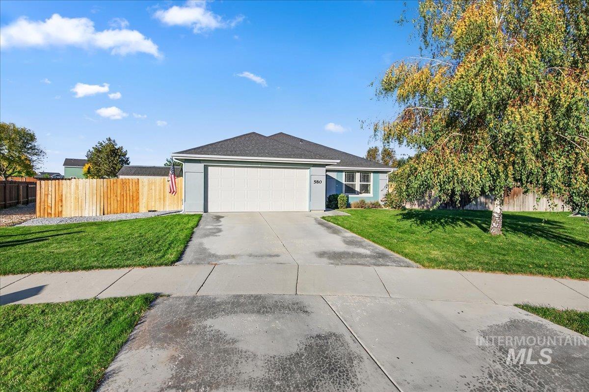 Ranch-style house with concrete driveway, a garage, stucco siding, and roof with shingles
