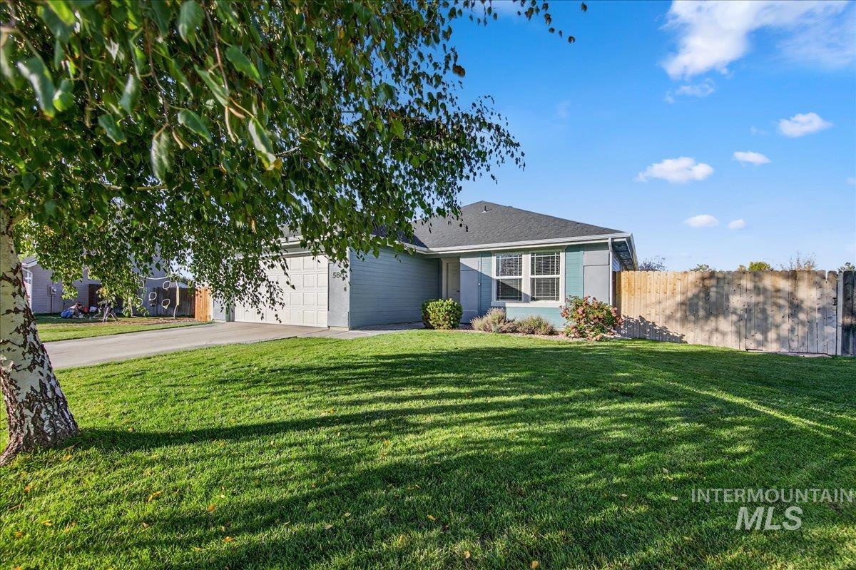 View of front of property with driveway and a garage