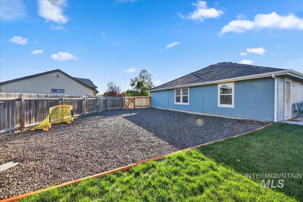 Back of house with a fenced backyard