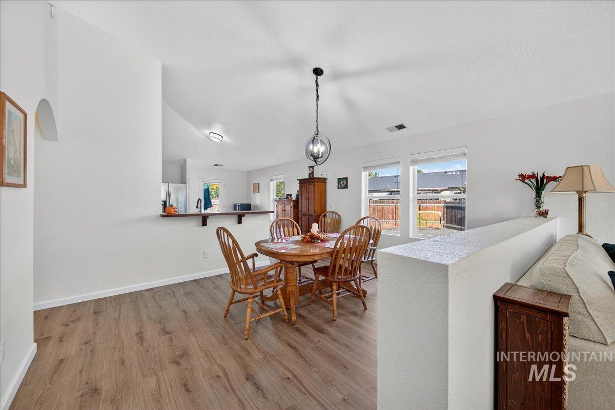 Dining area with light wood finished floors and baseboards