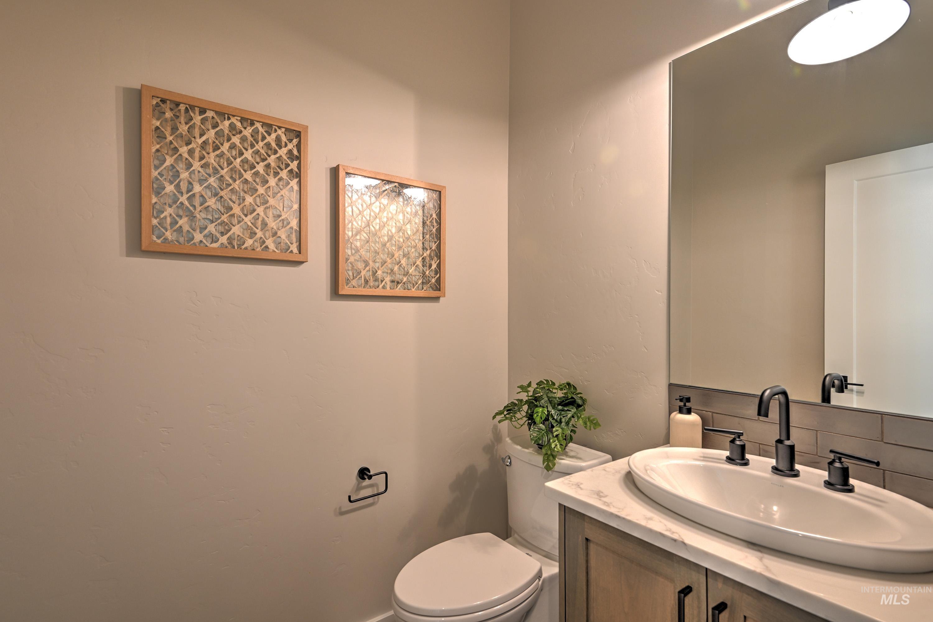 Half bath featuring vanity and toilet