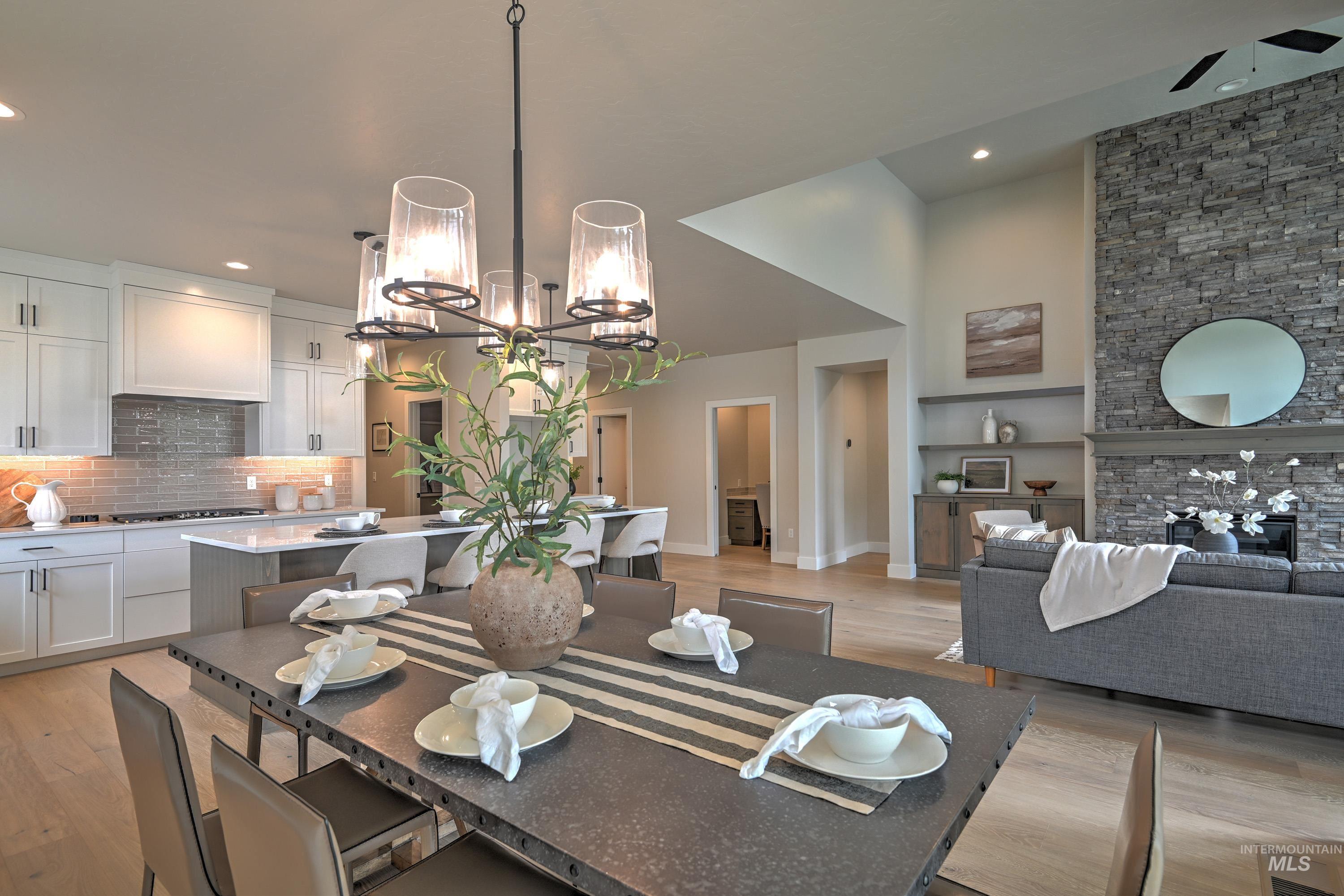 Dining room with light wood-type flooring, recessed lighting, a chandelier, and built in shelves