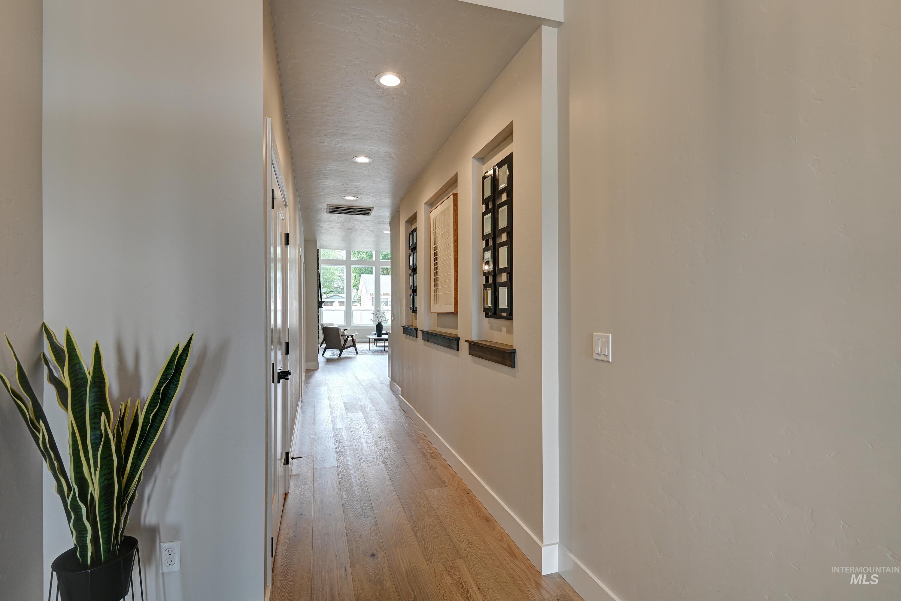 Corridor with recessed lighting and light wood-style flooring