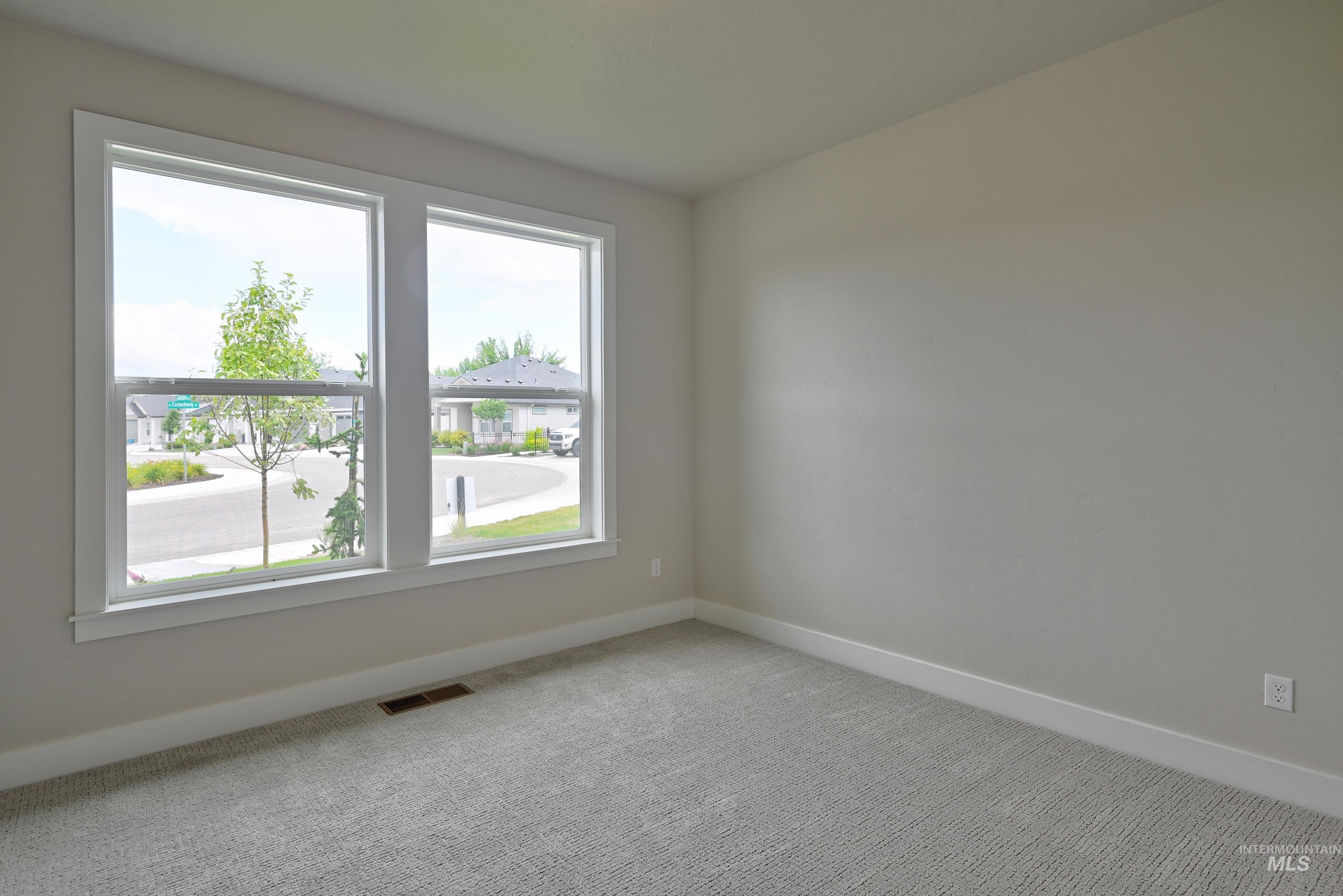 Unfurnished room featuring baseboards and carpet flooring