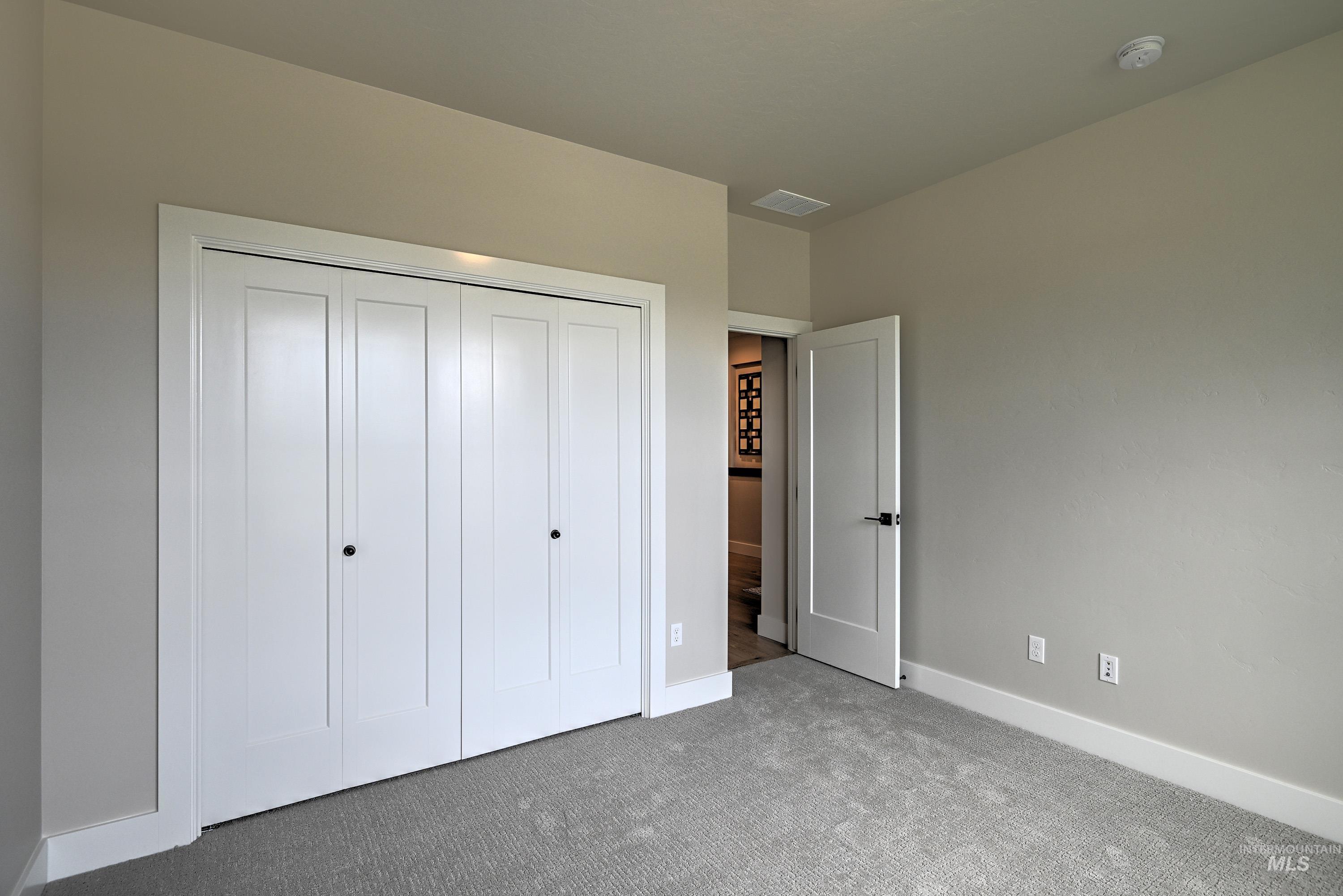 Unfurnished bedroom with carpet floors and a closet