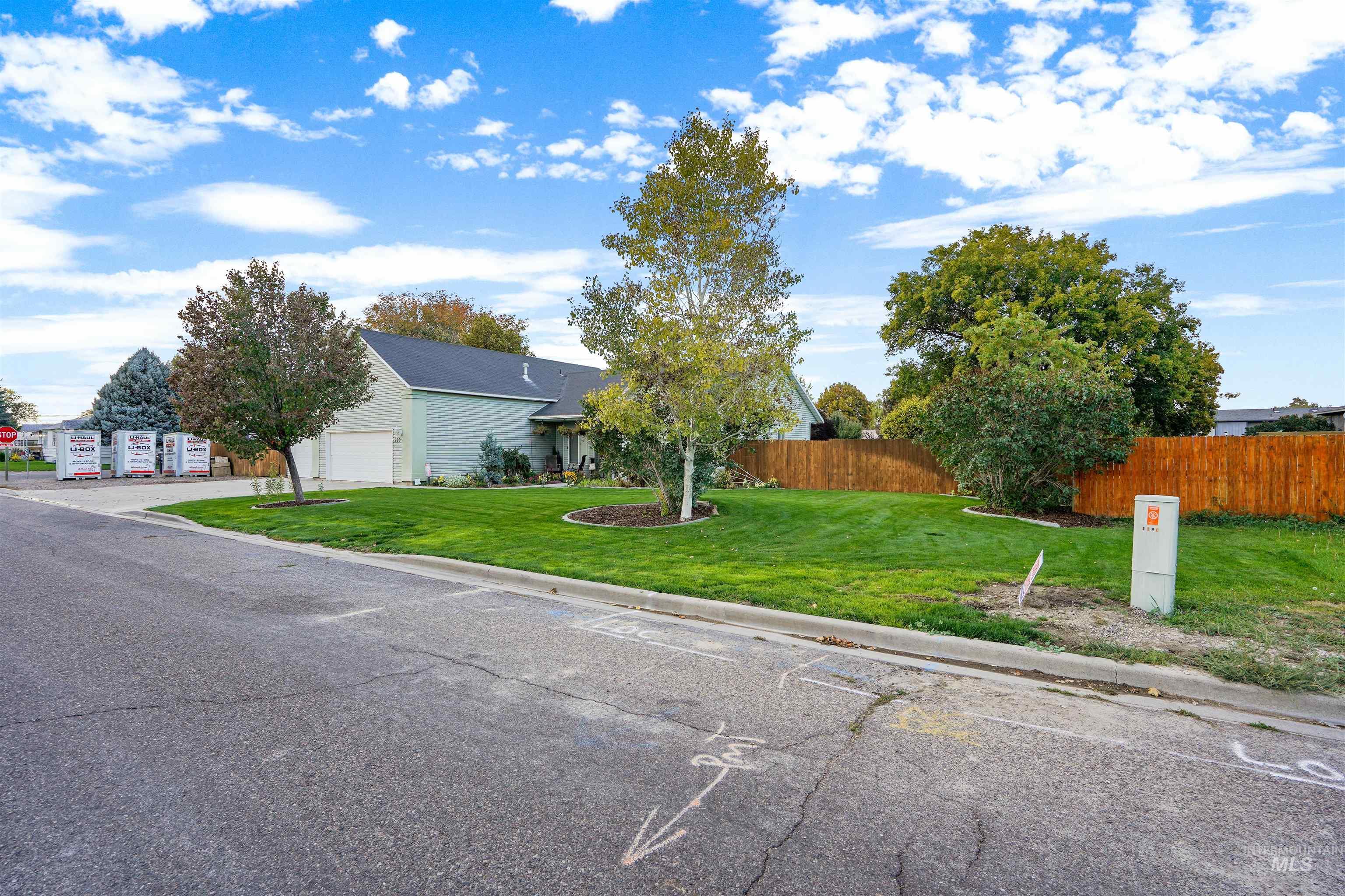 Obstructed view of property with a garage and driveway