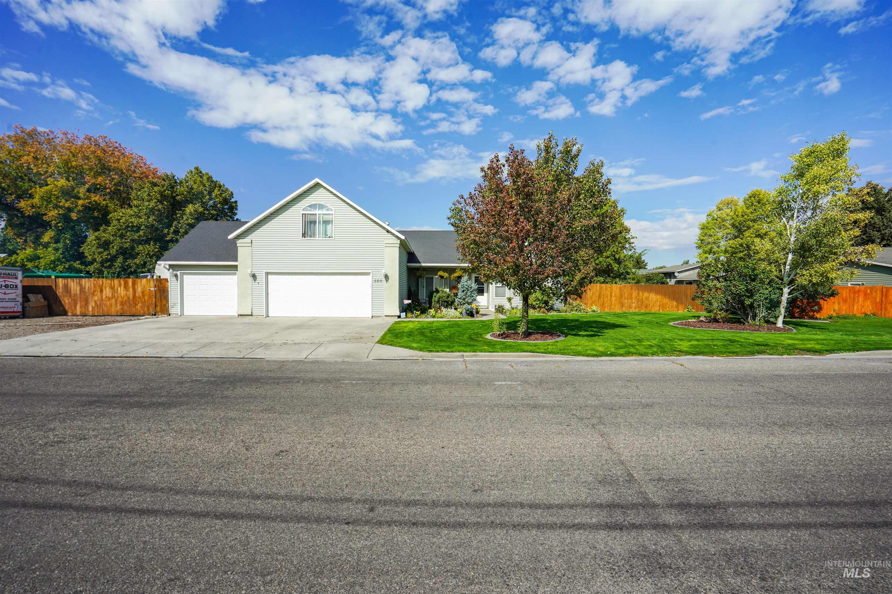 View of front of property featuring a garage and driveway