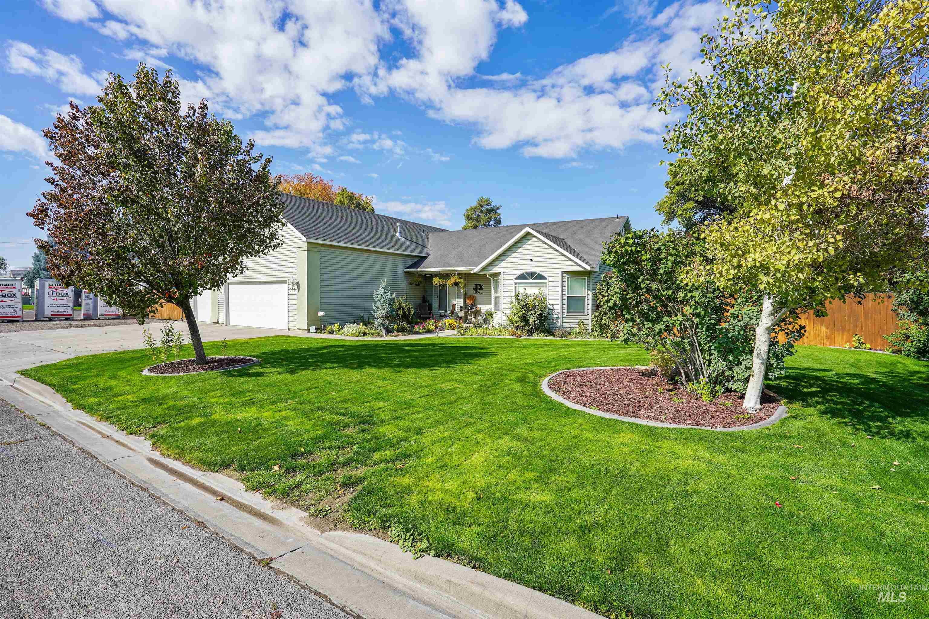 View of front of home with a front lawn, concrete driveway, and an attached garage