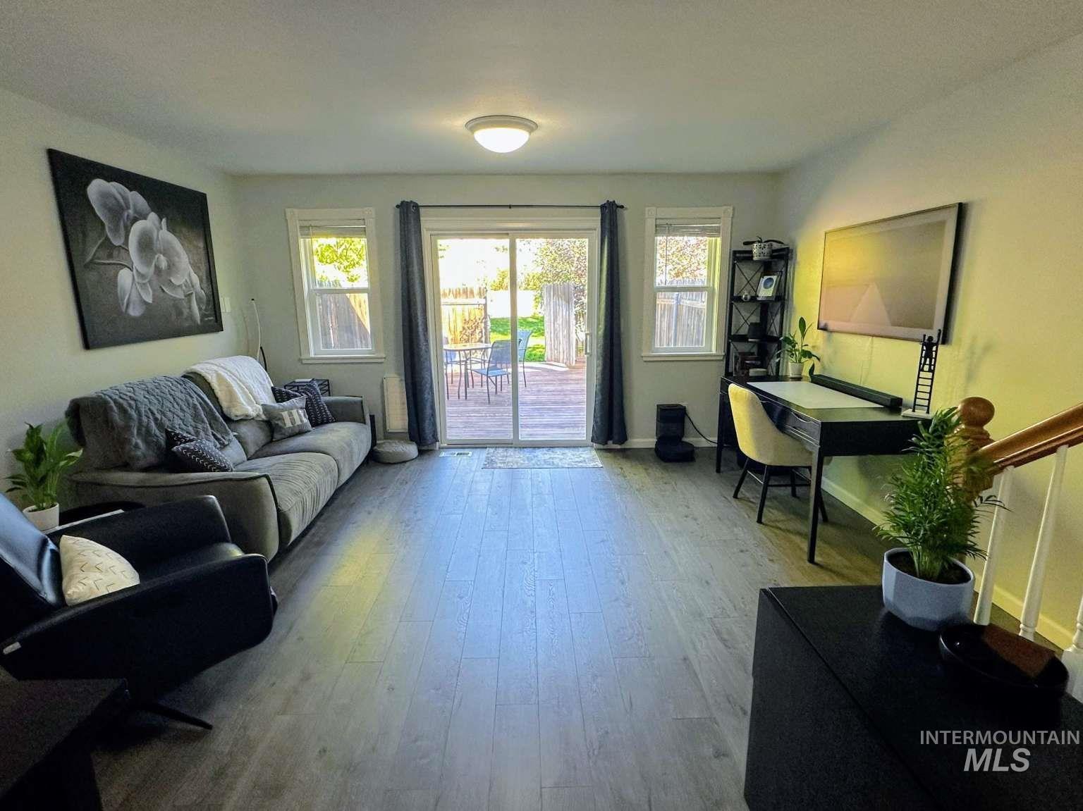 Living room featuring wood finished floors and stairs