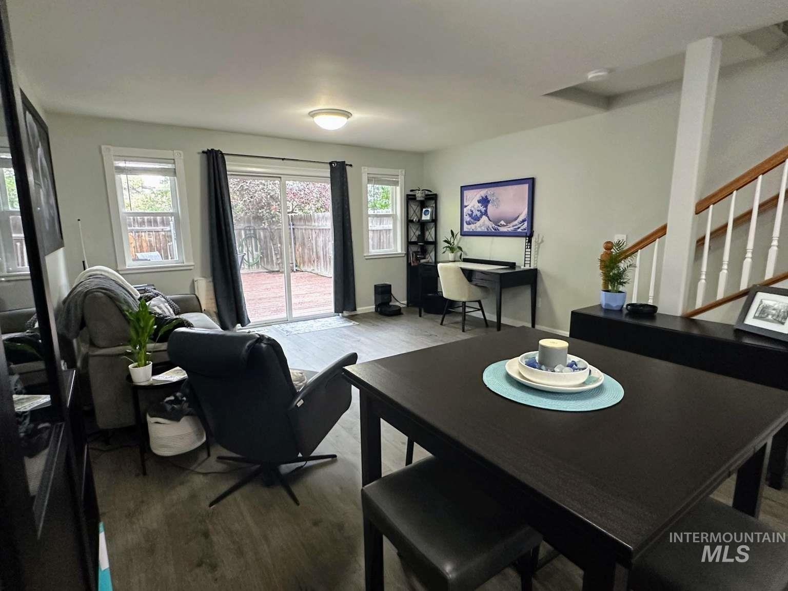 Dining space featuring wood finished floors and stairs