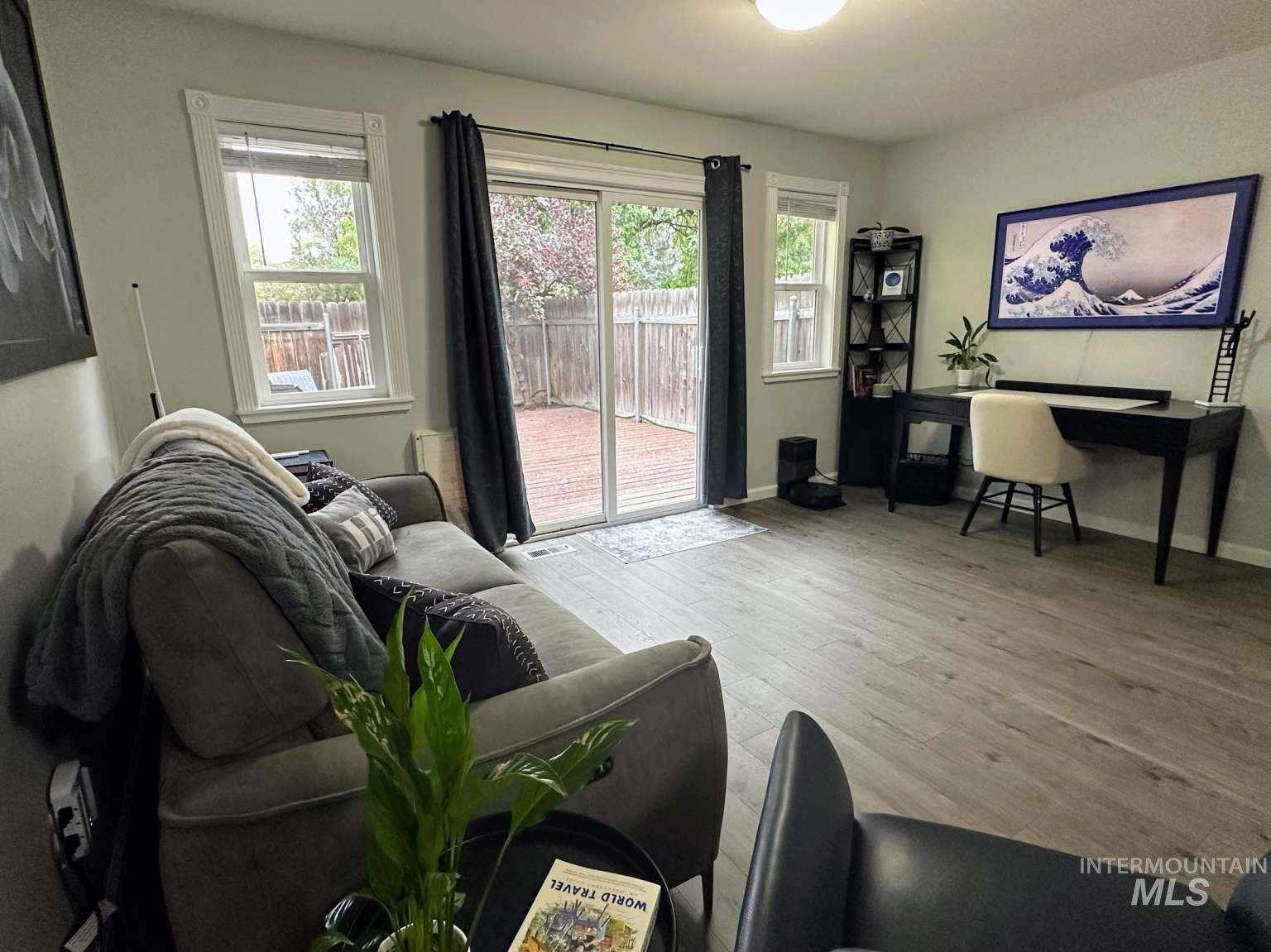 Living room featuring light wood-type flooring and baseboards