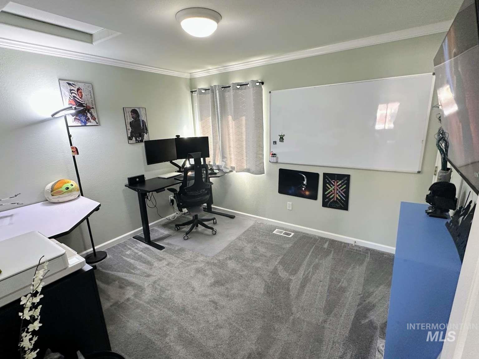 Office featuring crown molding and carpet