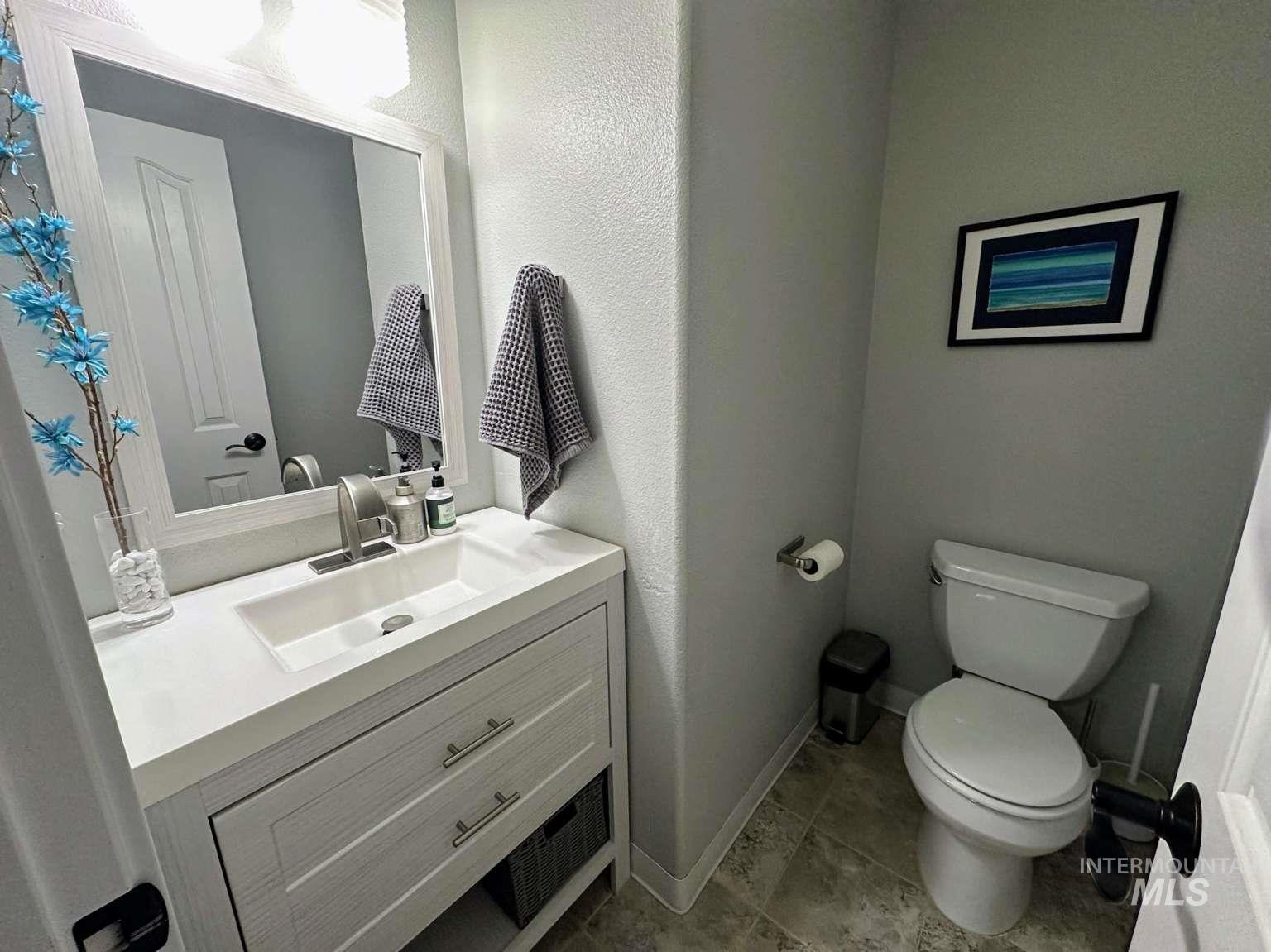 Bathroom featuring vanity and a textured wall