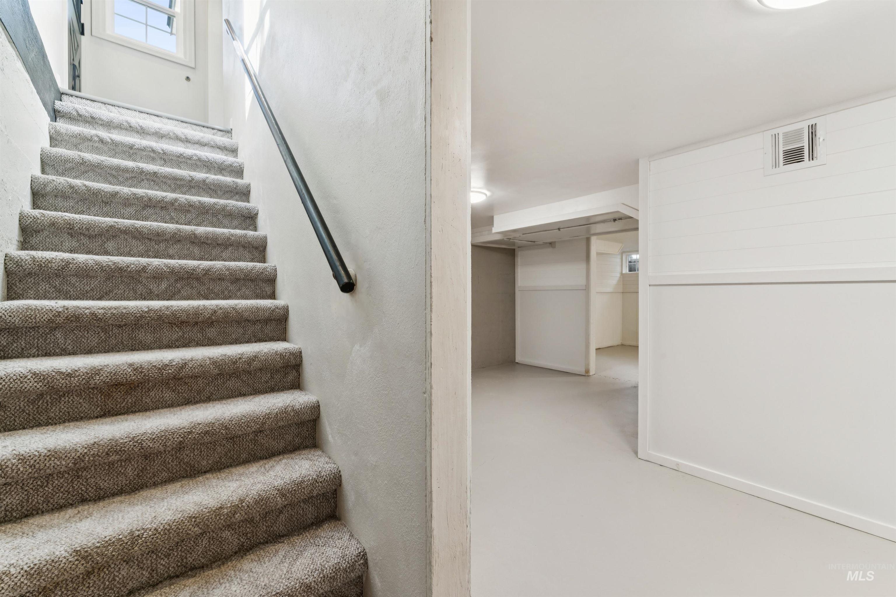 Stairs featuring finished concrete flooring
