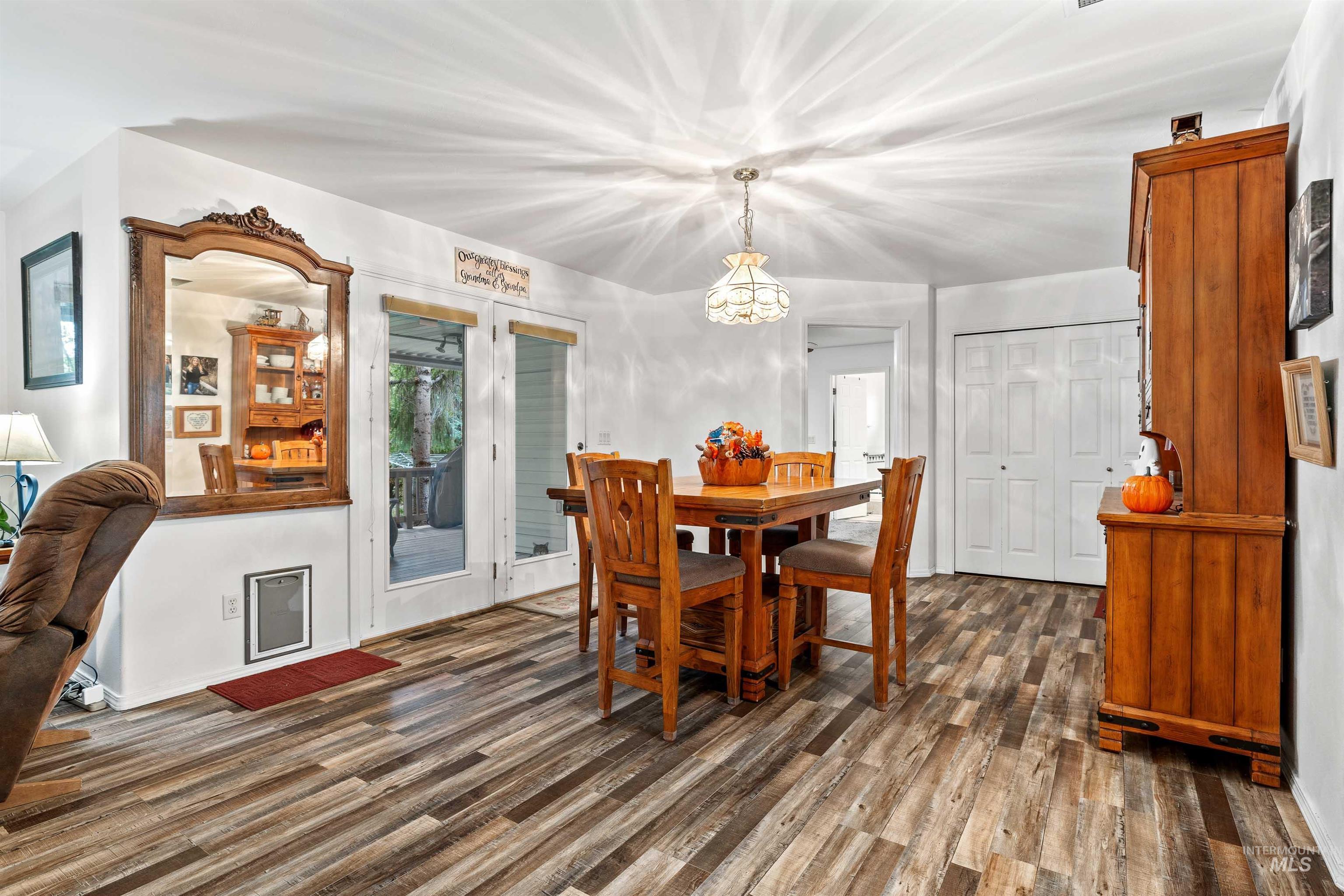 Dining area with dark wood finished floors and a chandelier