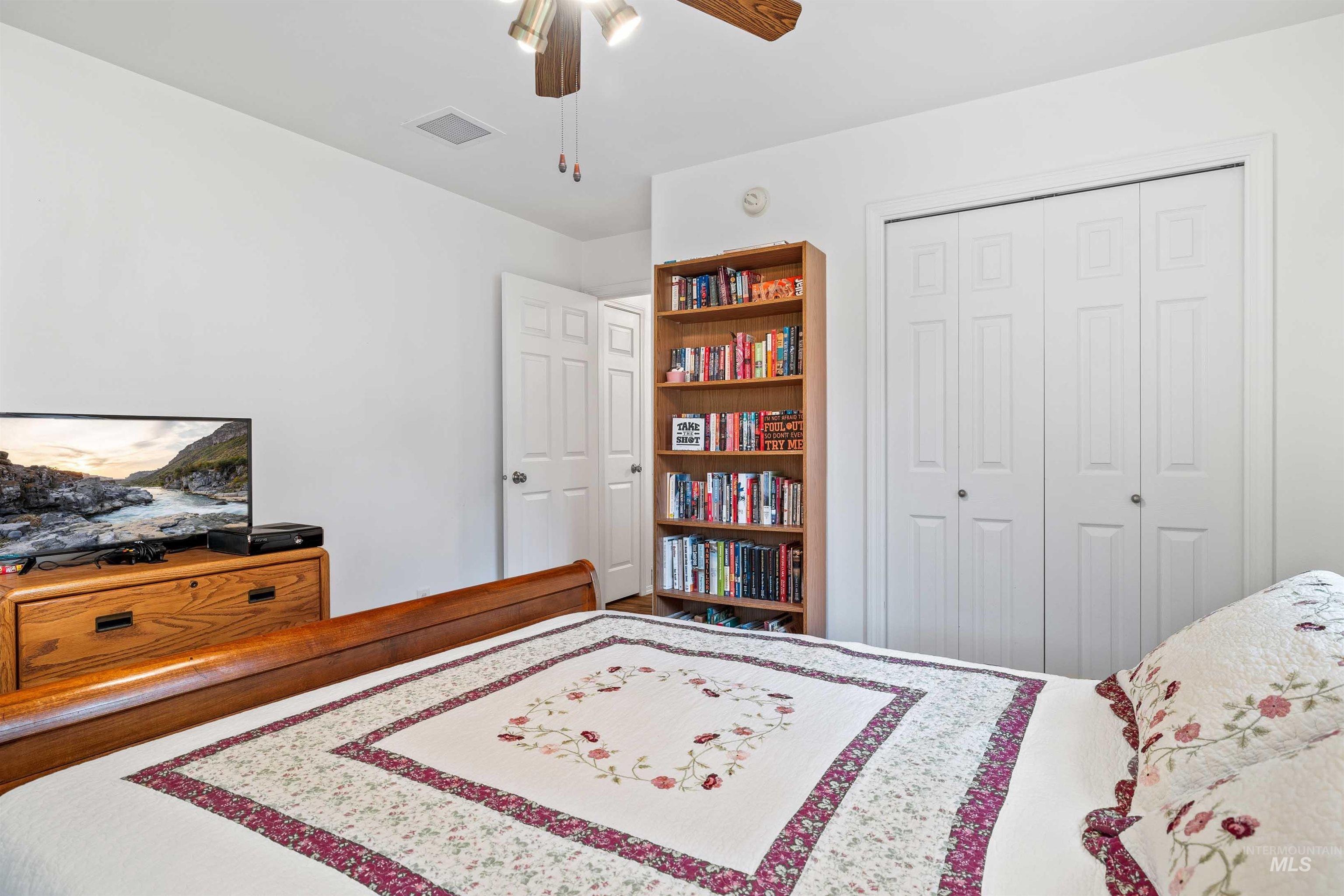 Bedroom featuring a ceiling fan and a closet