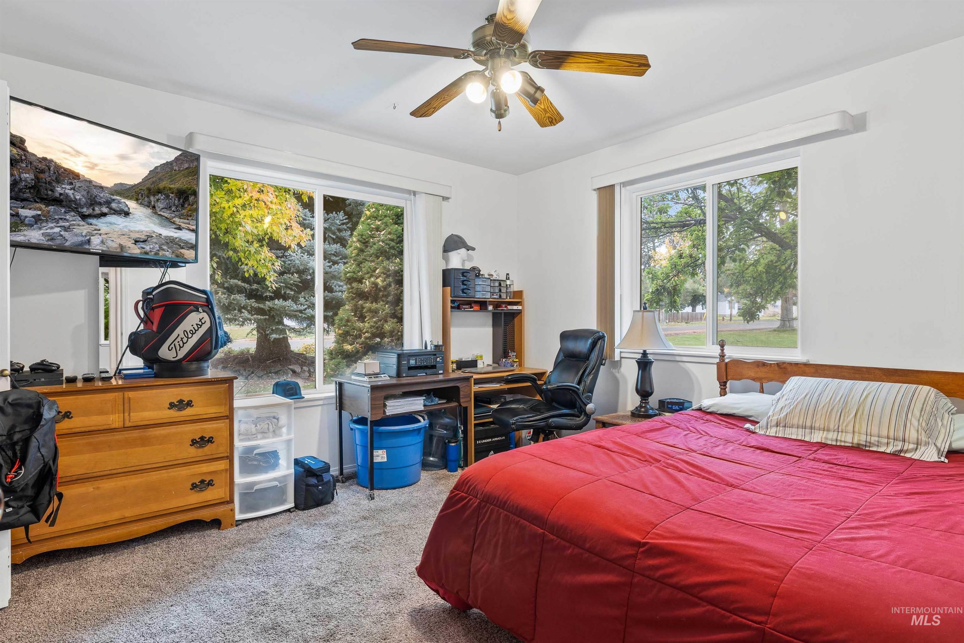 Bedroom featuring a desk, carpet, and ceiling fan