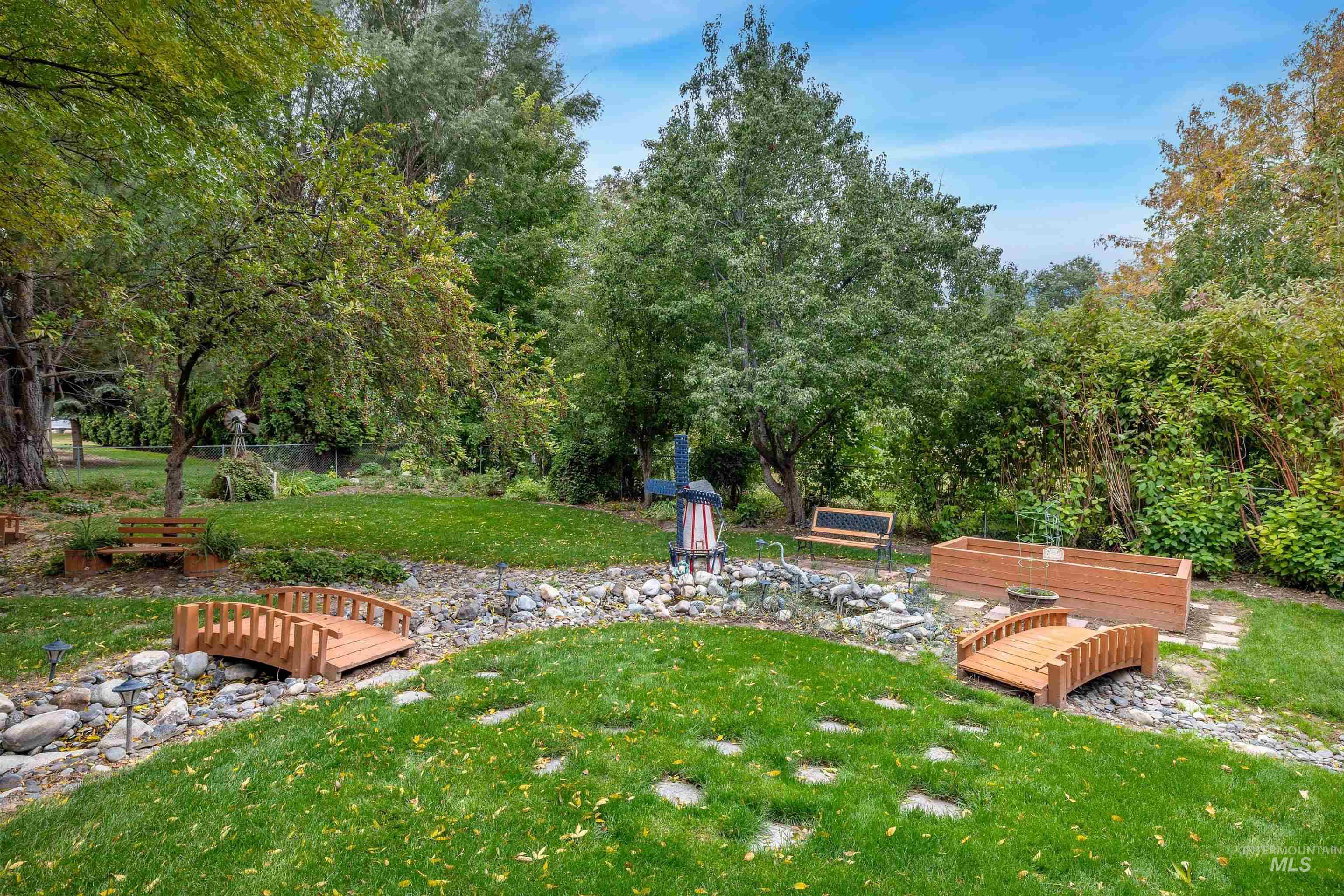 View of property's community with view of scattered trees and a wooden deck