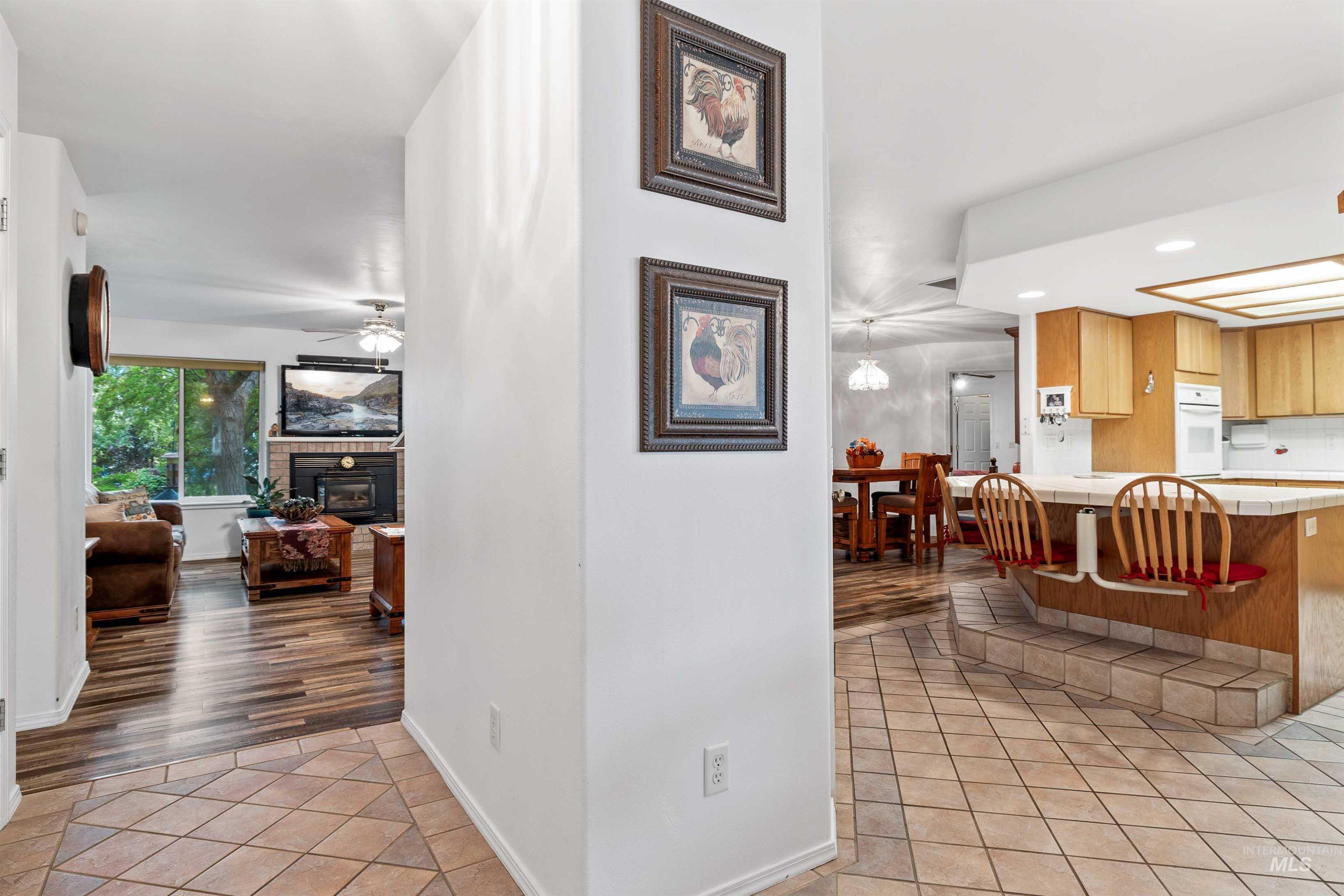 Hall with light tile patterned floors and recessed lighting