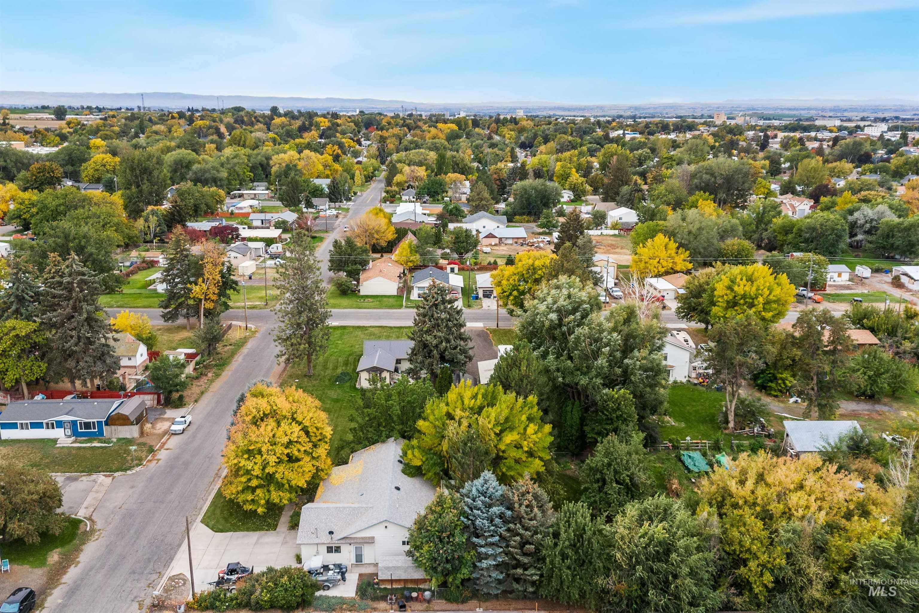 Aerial view of residential area featuring a tree filled landscape