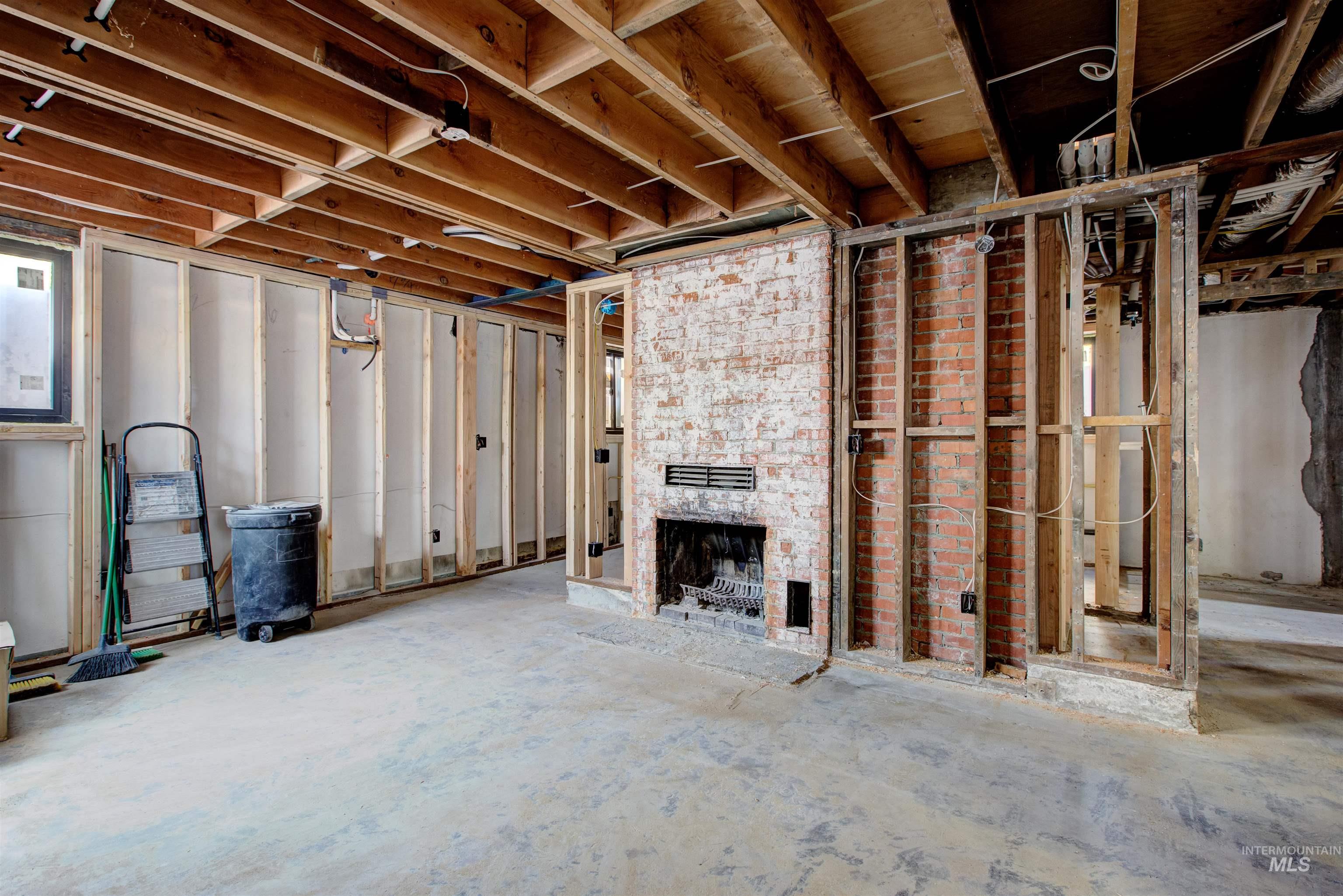 Unfinished below grade area with a large fireplace