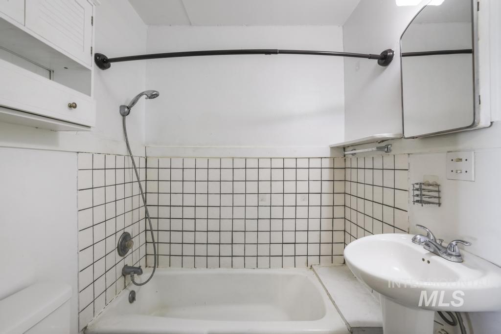 Full bath featuring shower / bath combination and toilet