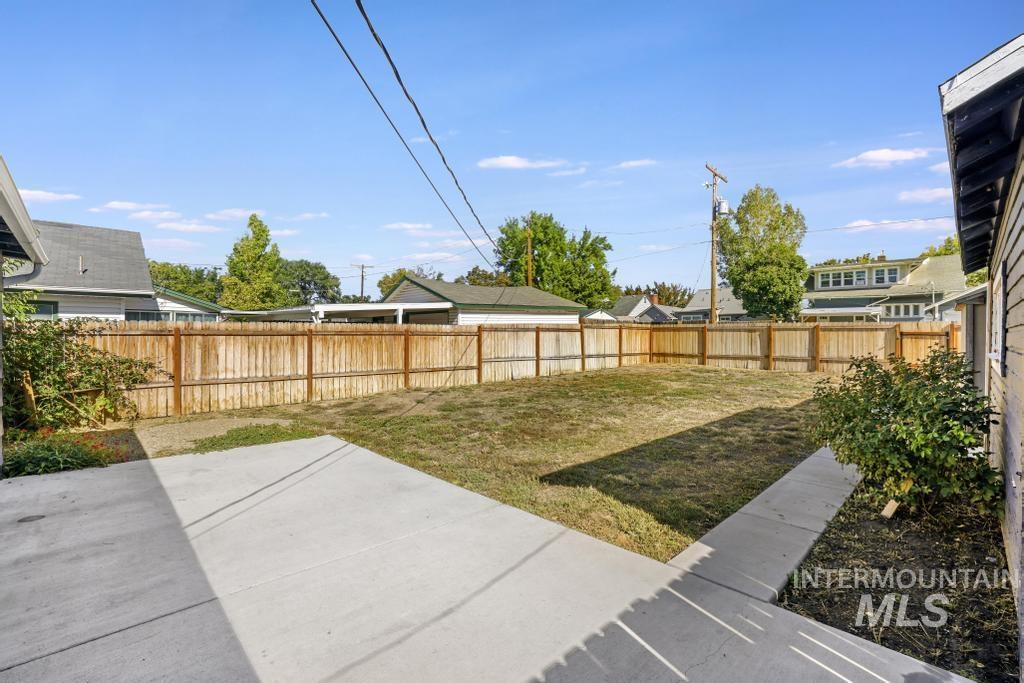 Fenced backyard with a patio area