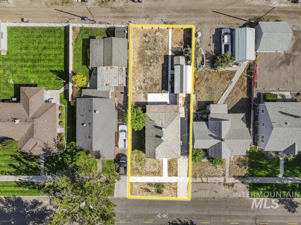 Aerial perspective of suburban area featuring property boundaries highlighted