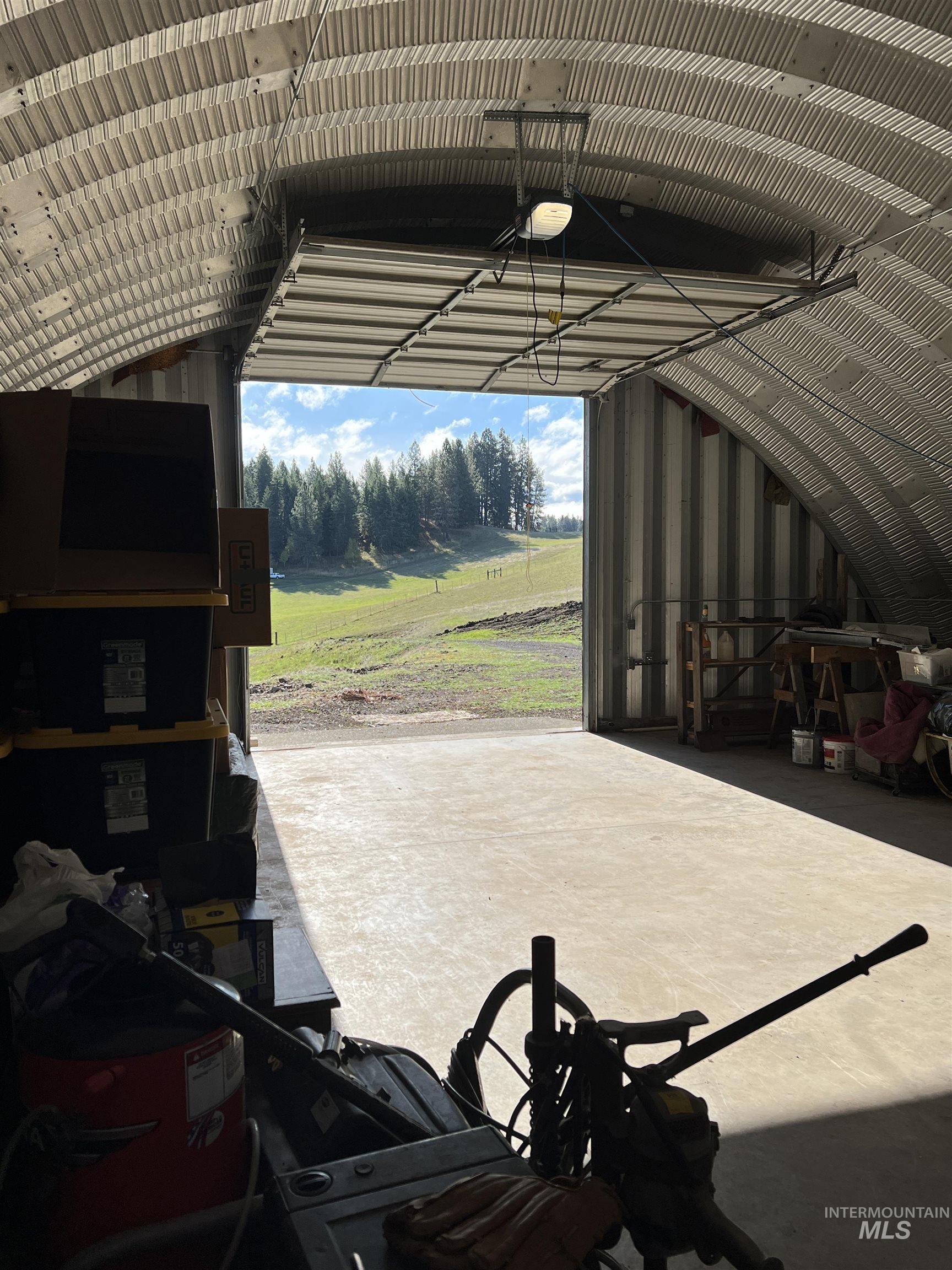 Garage featuring a garage door opener and metal wall