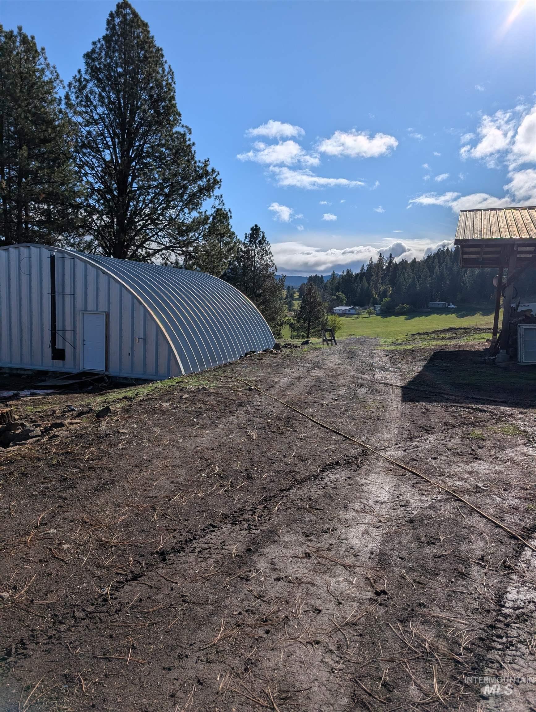 View of yard featuring an outbuilding and a pole building