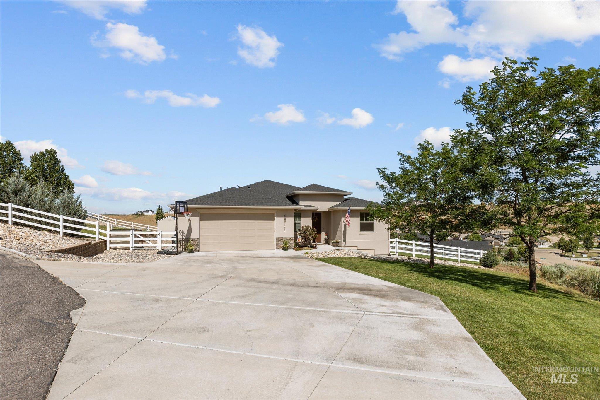 View of front of house featuring an attached garage and driveway