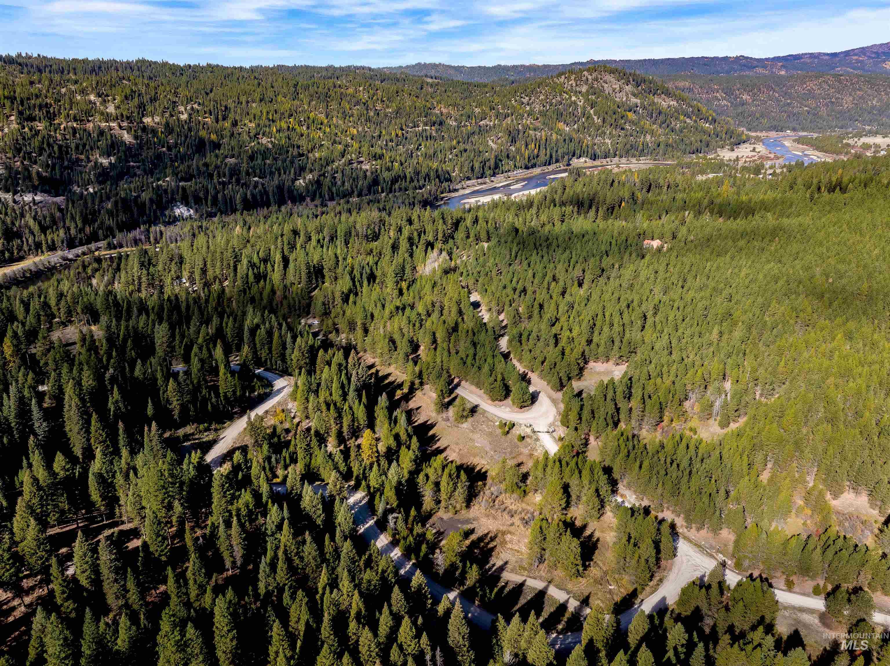 Aerial view of property's location with a mountainous background