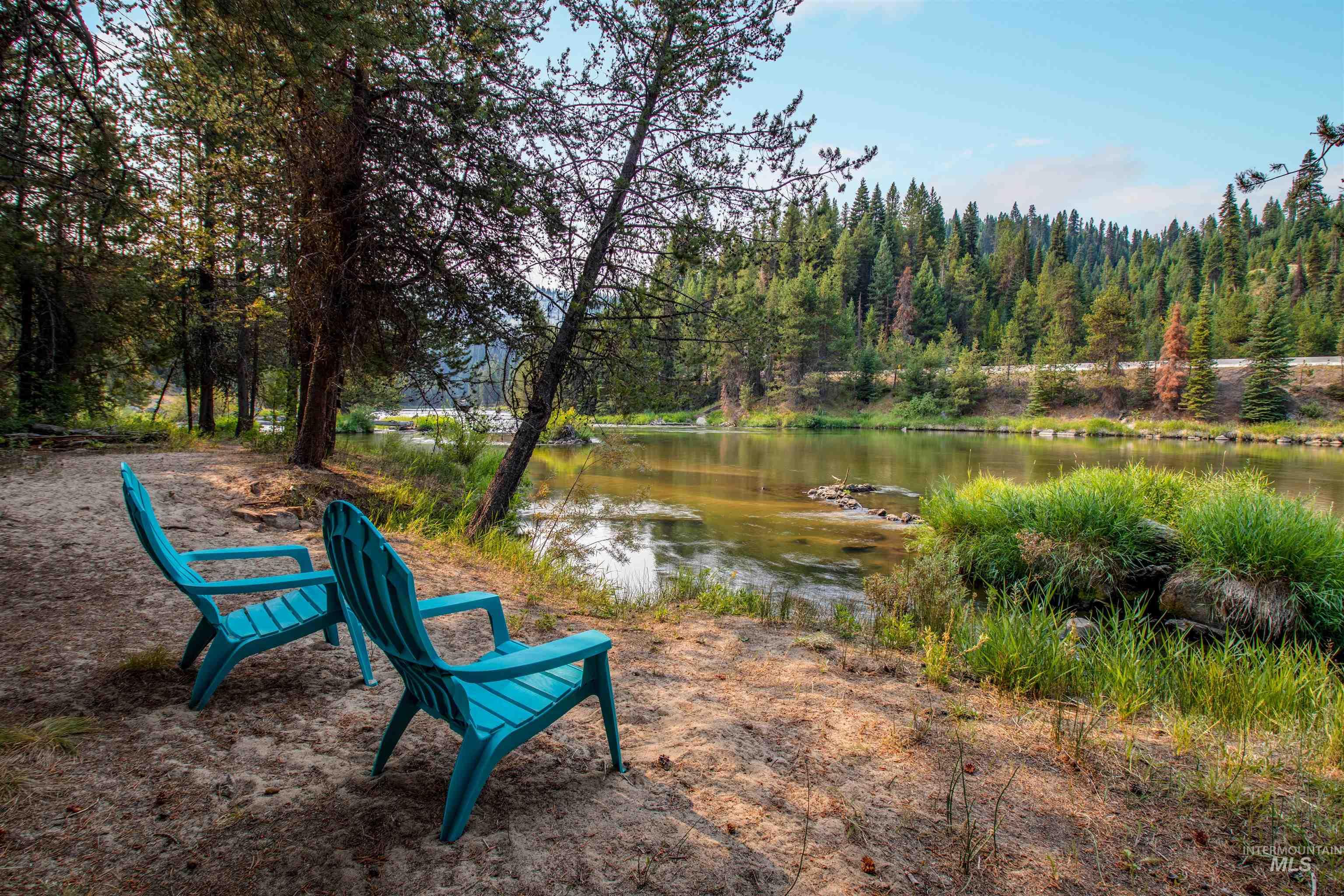 View of property's community featuring a water view and a wooded view